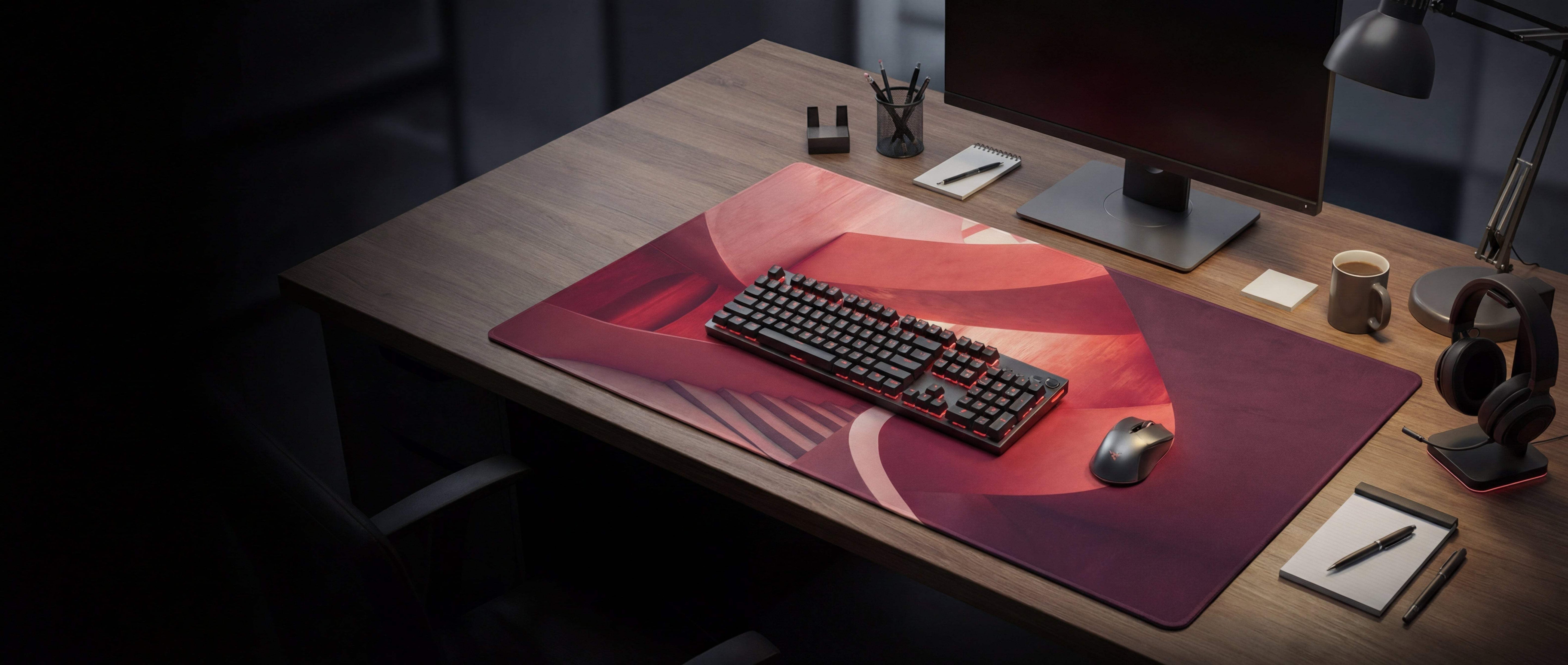 Red and purple abstract design gaming mousepad with a black mechanical keyboard resting on it.