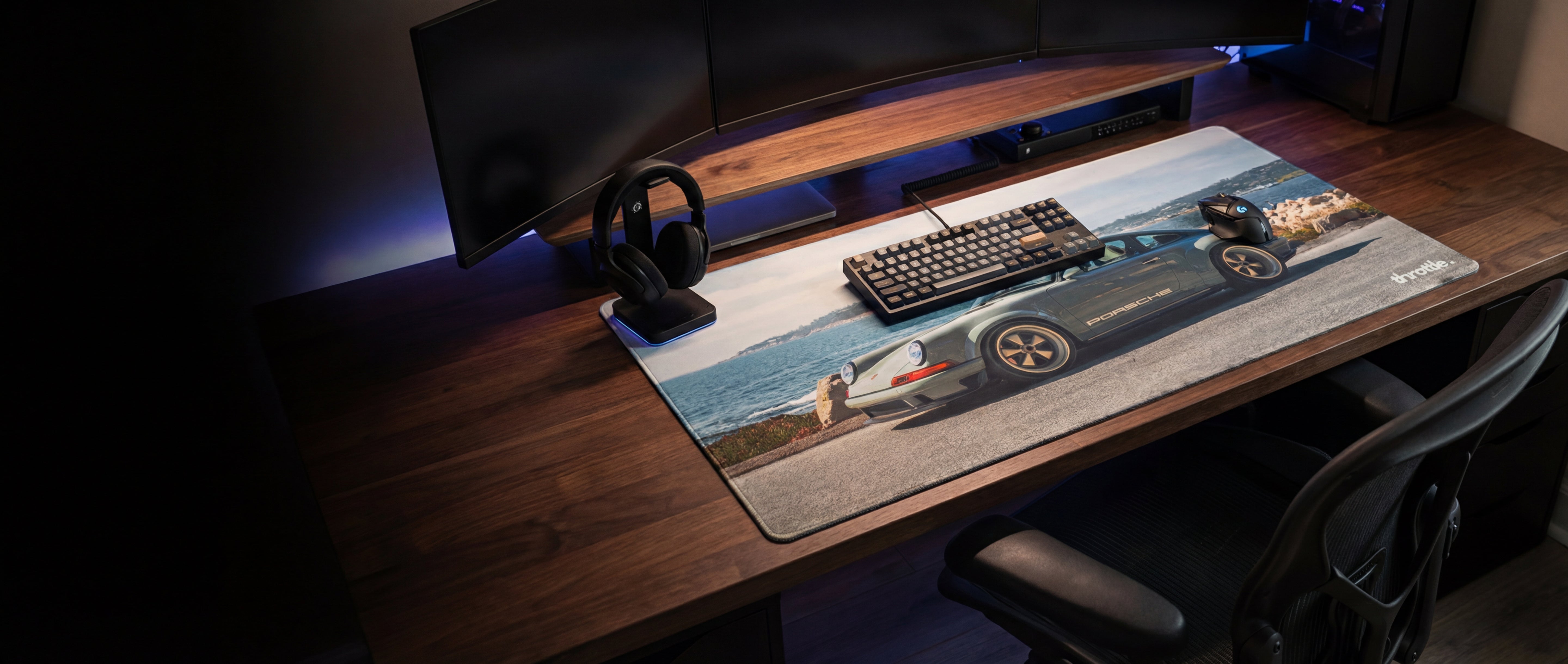 A sleek, gray porsche 911-themed gaming mousepad with a detailed car graphic and subtle blue led backlighting along its edge.
