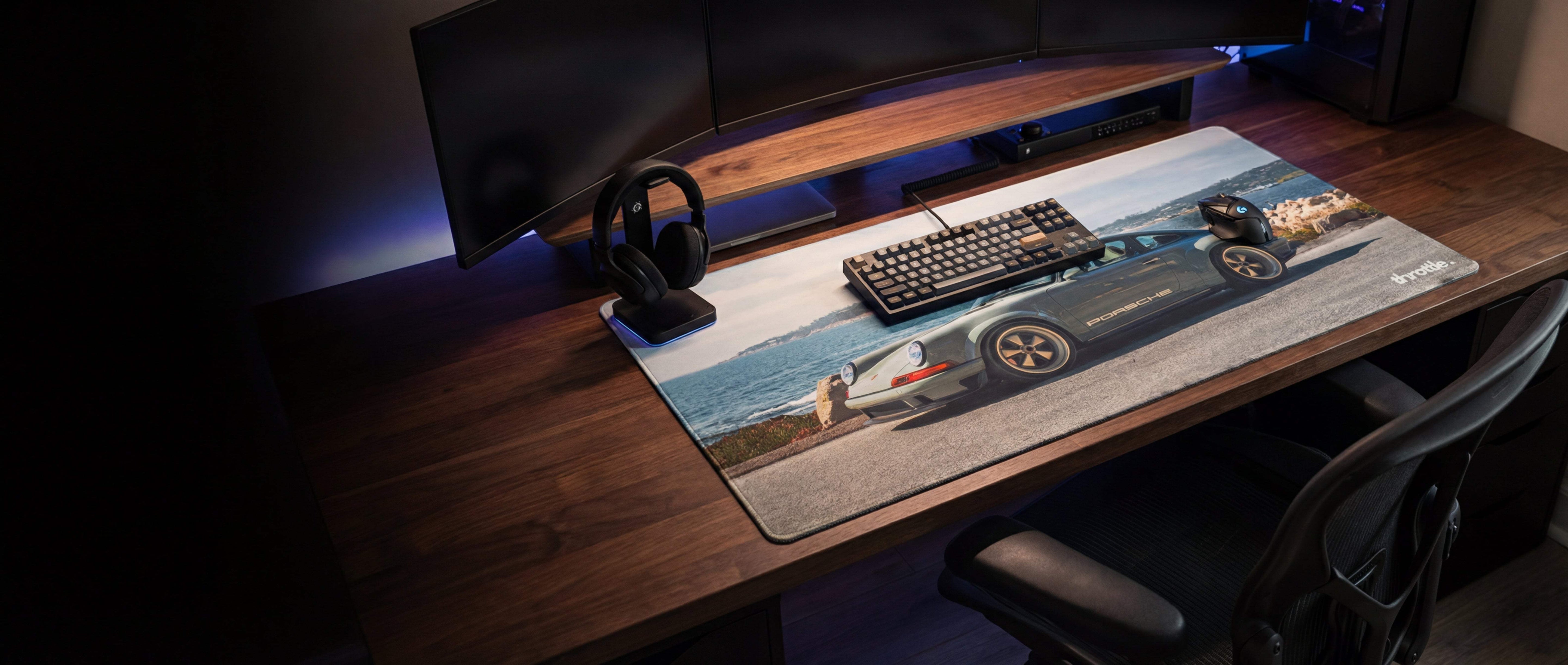 A sleek, gray porsche 911-themed gaming mousepad with a detailed car graphic and subtle blue led backlighting along its edge.