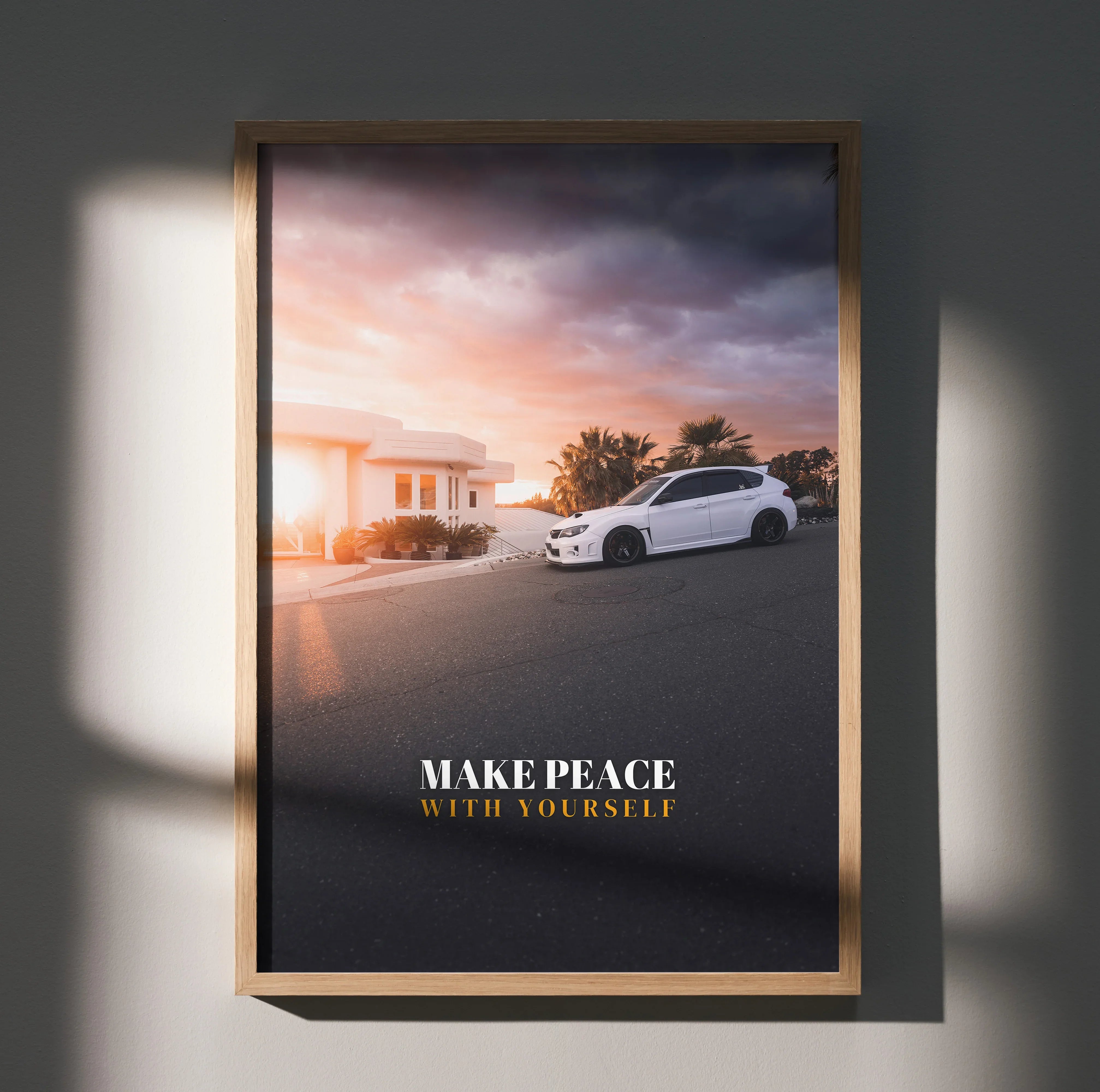 Motivational poster wall art featuring a white Subaru WRX STI at sunset with "Make Peace With Yourself" text.