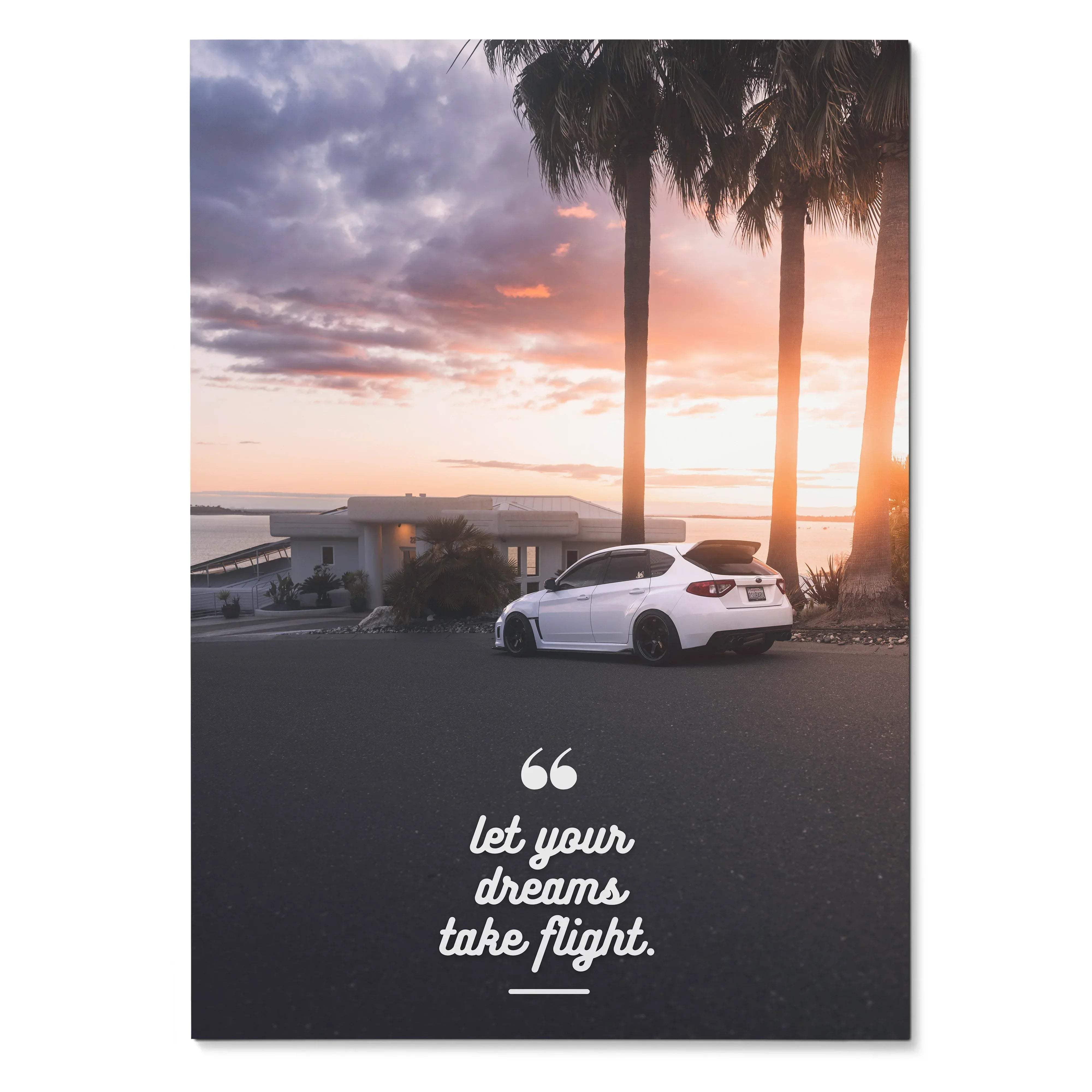 Subaru WRX STI parked by palm trees at sunset with "let your dreams take flight" motivational poster wall art.