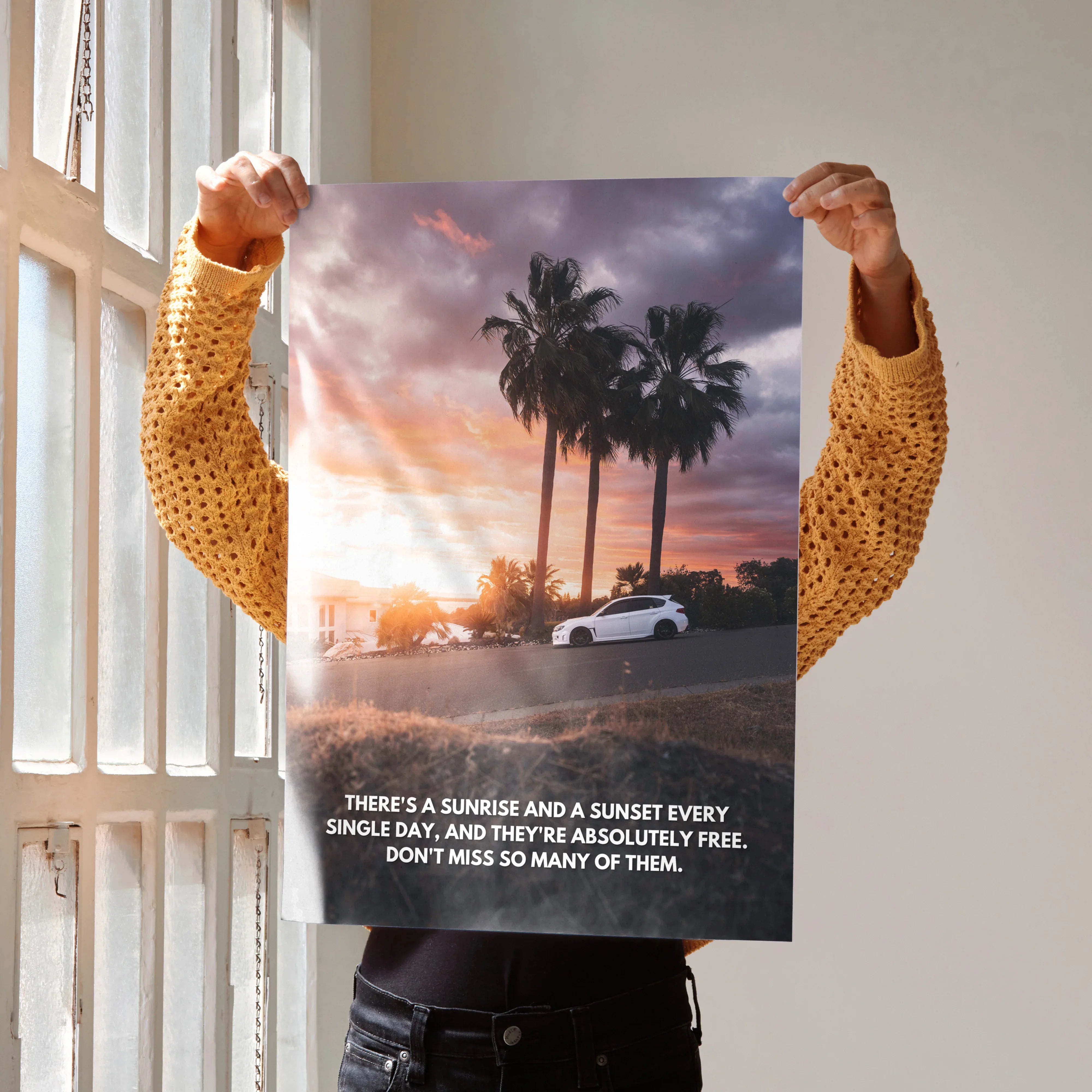 Motivational poster wall art of a white Subaru WRX STI with palm trees at sunset and inspiring text.