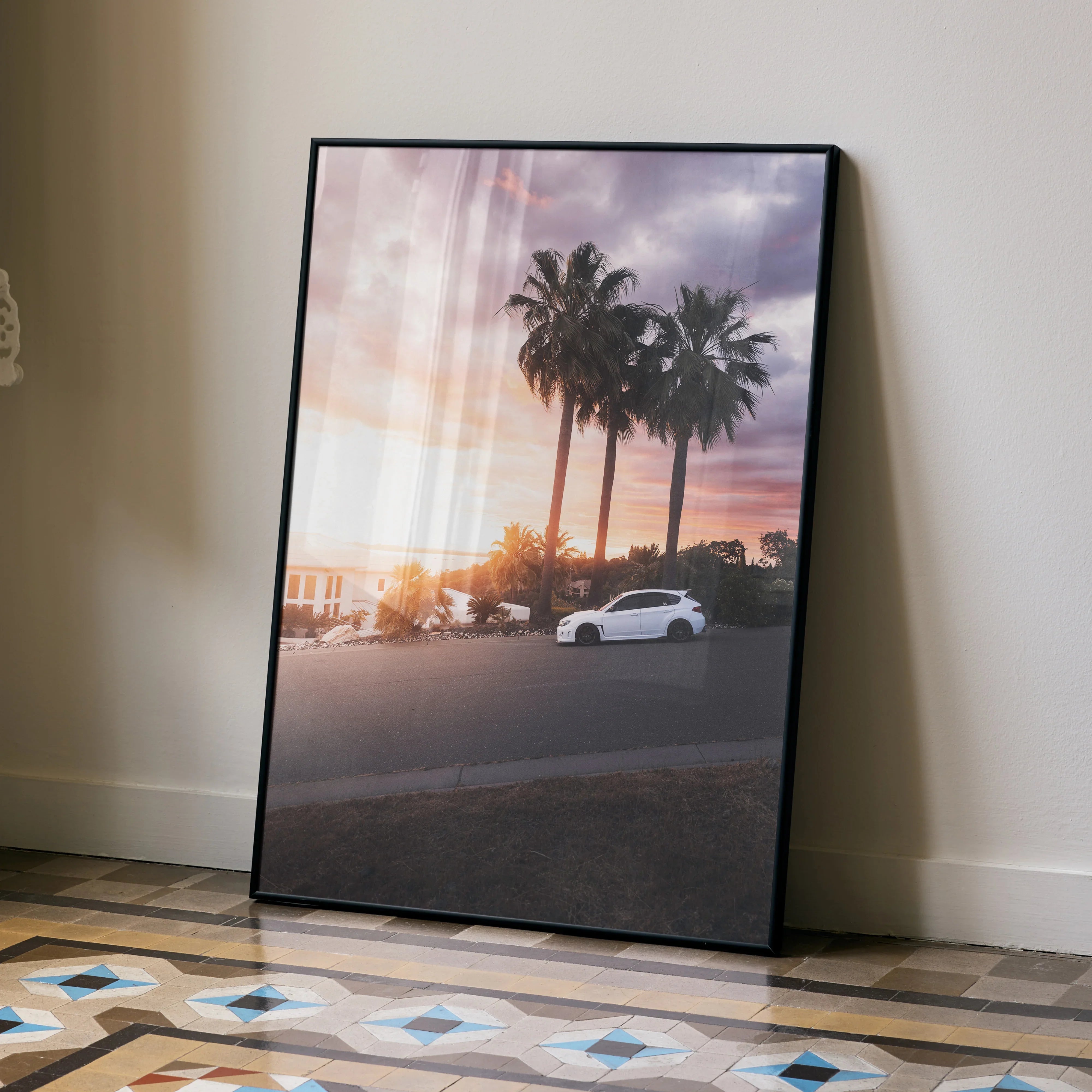Subaru WRX STI poster with sunset and palm trees, modern automotive wall art in black frame.