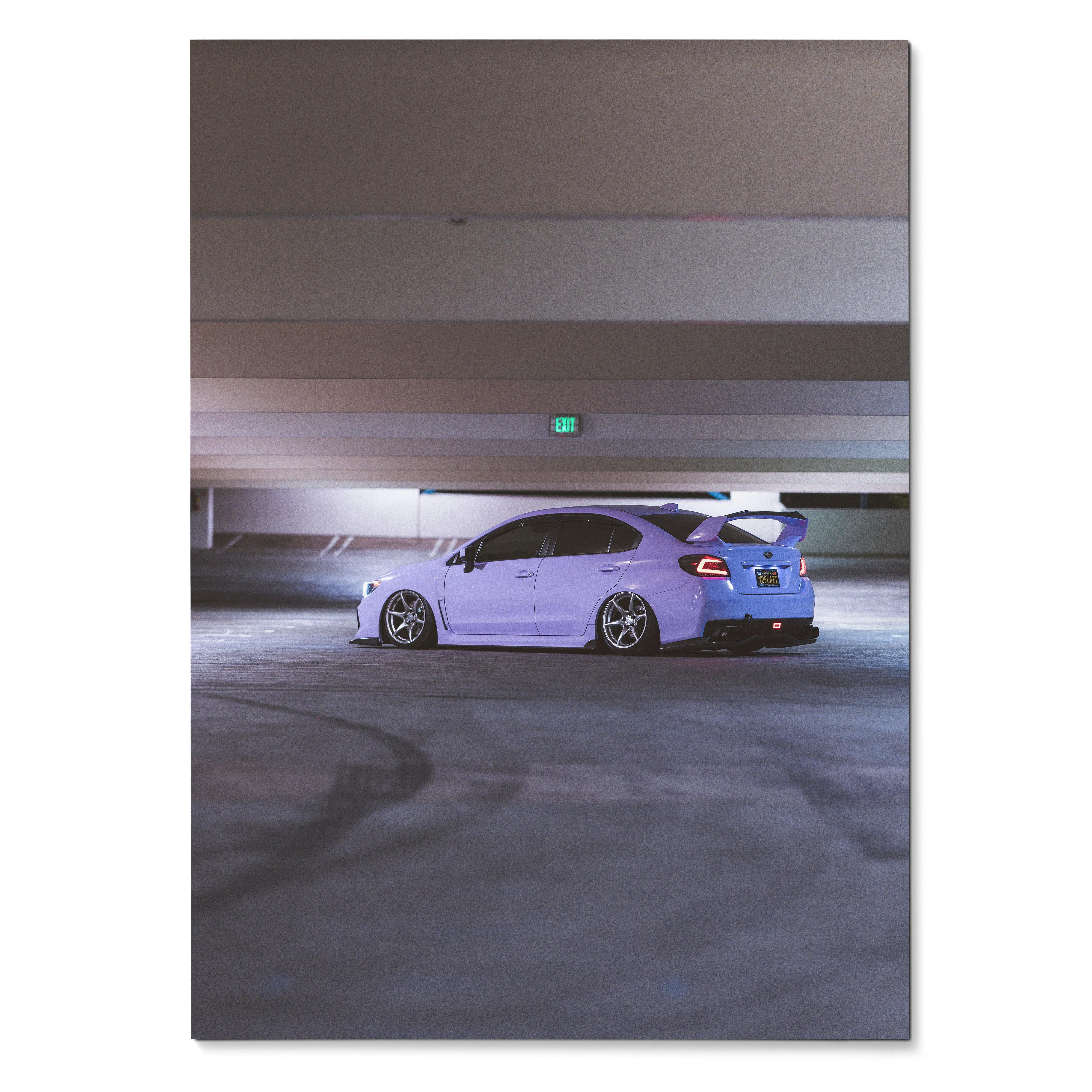 Subaru WRX in white with rear spoiler in dimly lit parking garage poster wall art.