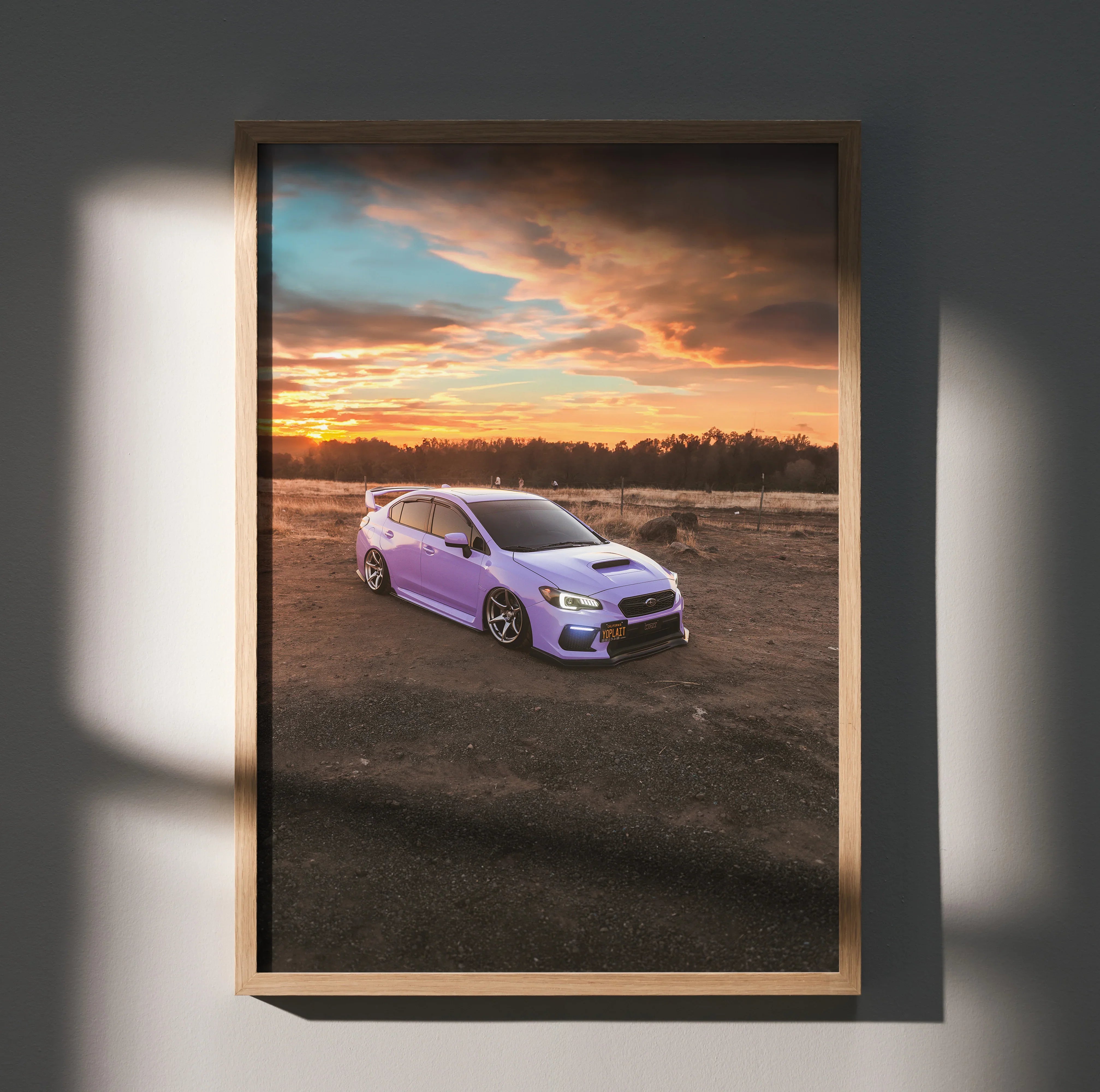 Subaru WRX poster wall art with purple car on dirt road under dramatic sunset sky.