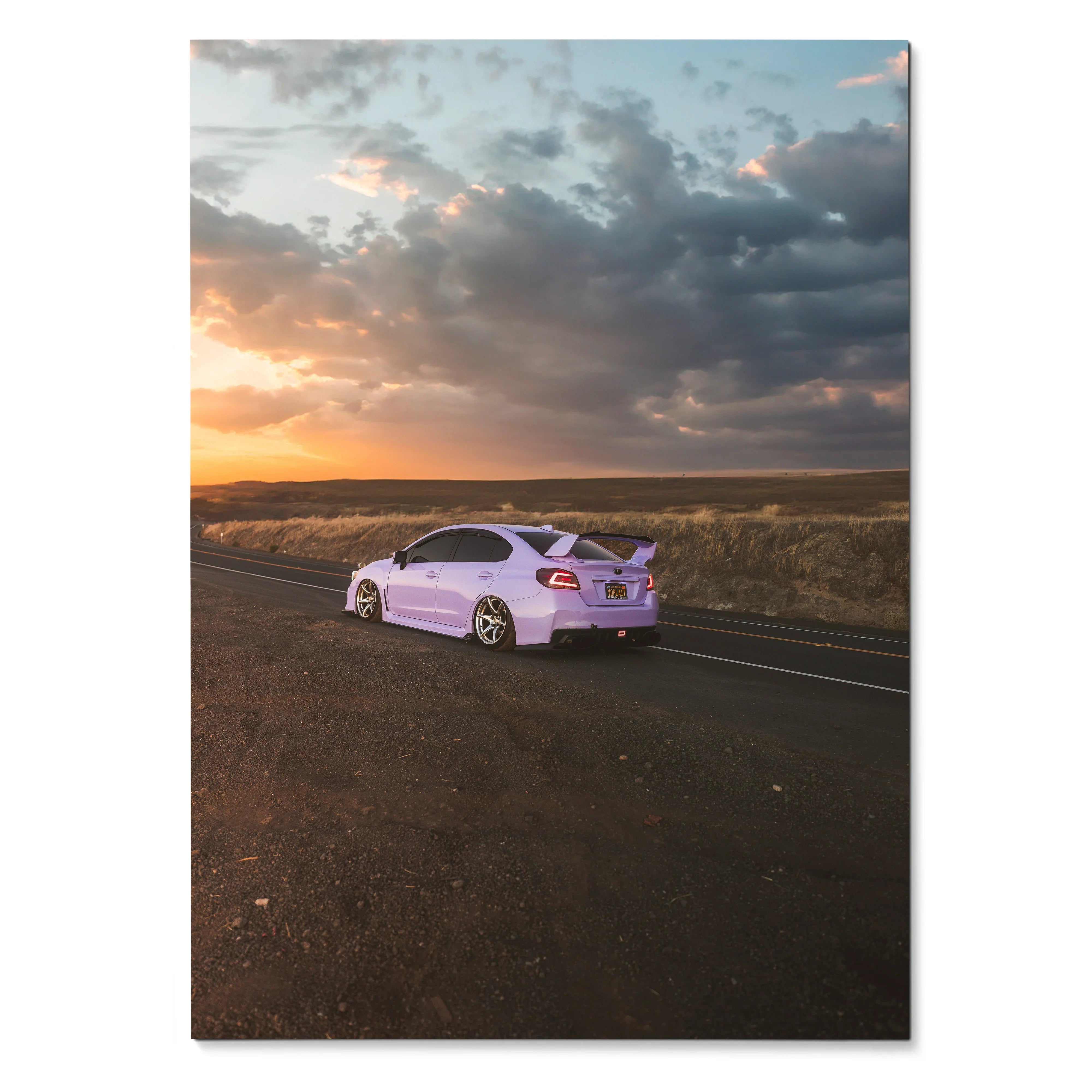Subaru WRX parked on road at sunset with dramatic sky poster wall art.