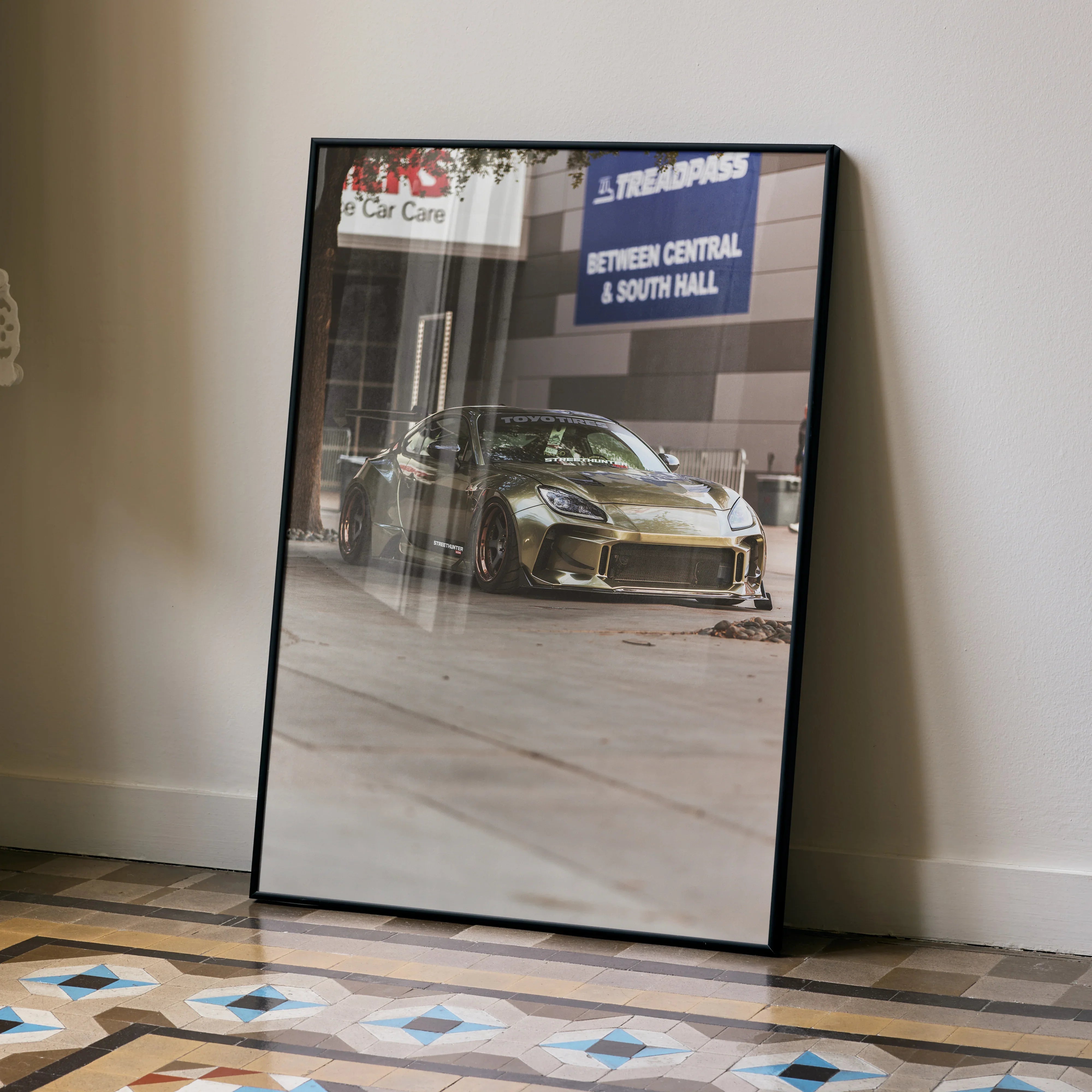 Subaru BRZ poster wall art featuring a high-resolution photo of a gold BRZ sports car in a garage setting.