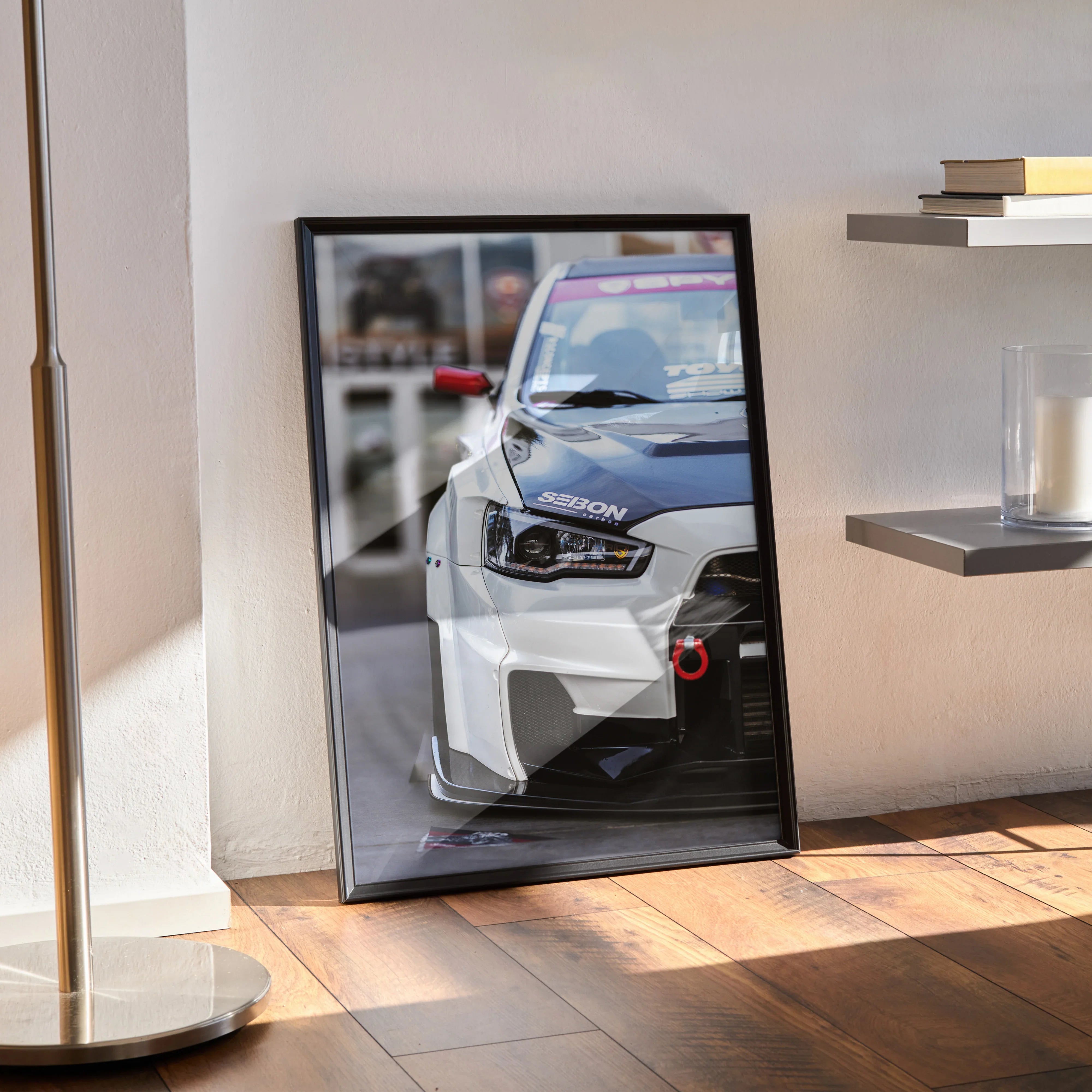 Mitsubishi Evo 10 close-up poster wall art with sharp focus on front headlight and grille, in black frame.