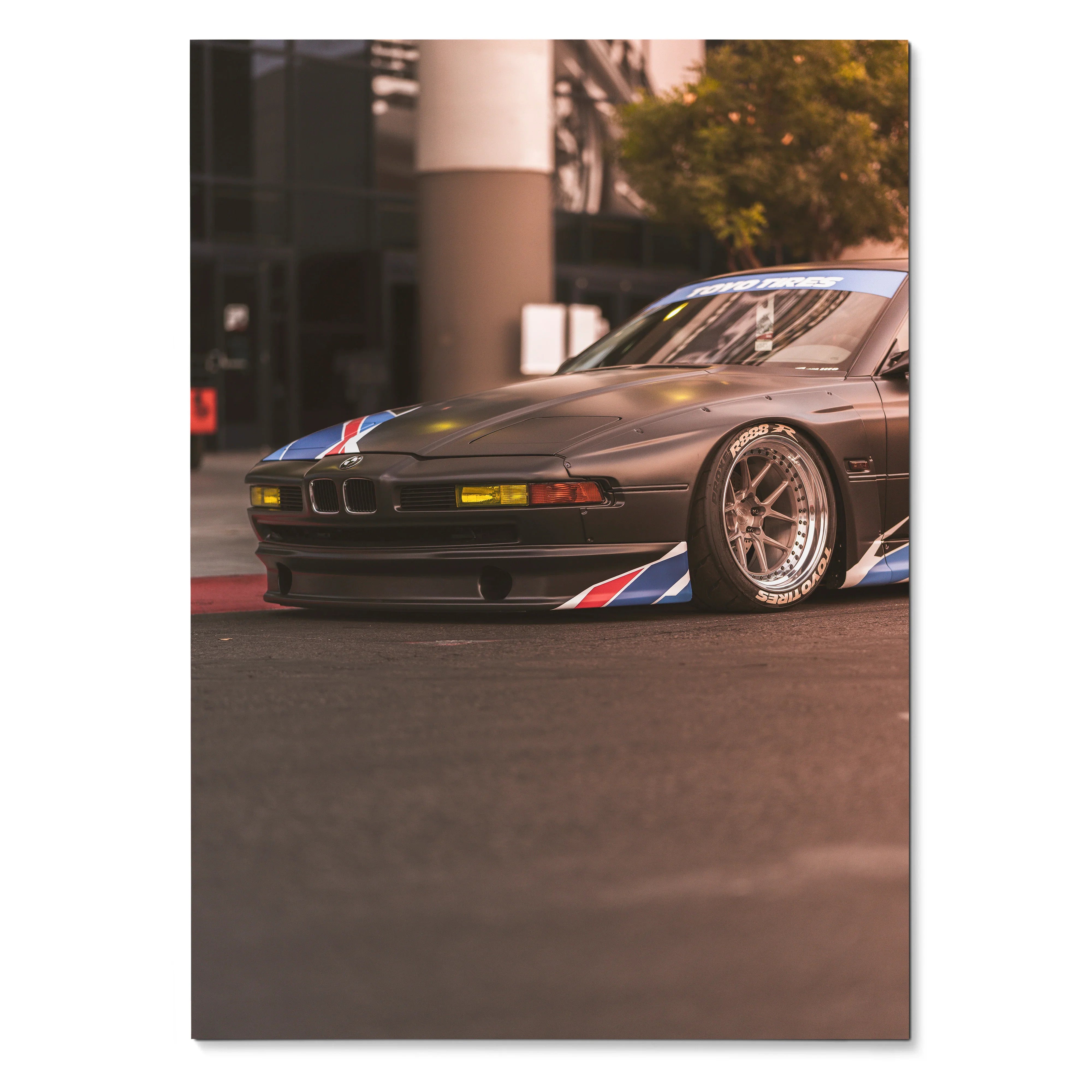 BMW E31 850ci classic car poster with sleek black body and racing stripes, automotive wall art.