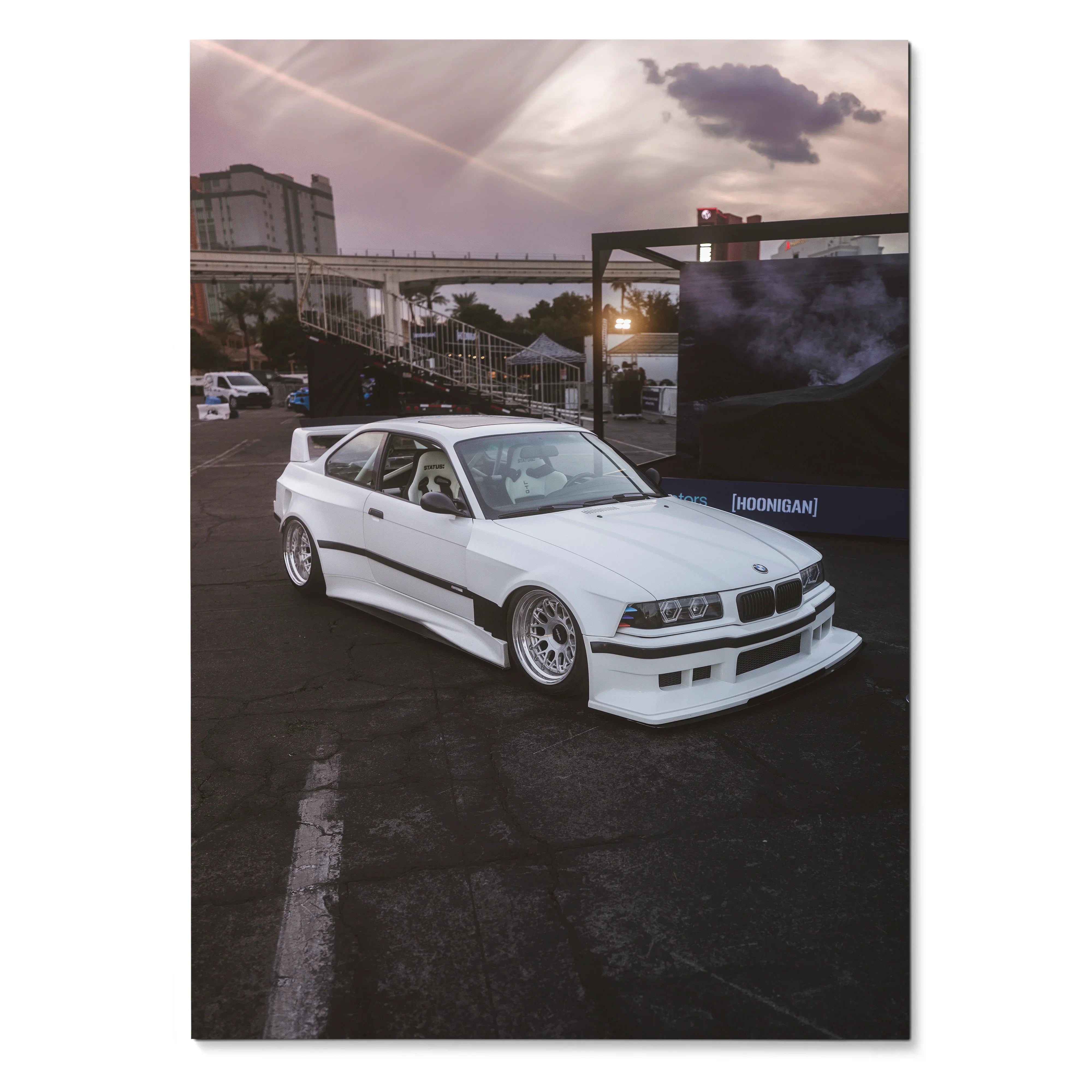 White BMW E36 M3 sports car parked at dusk with urban industrial background poster wall art.