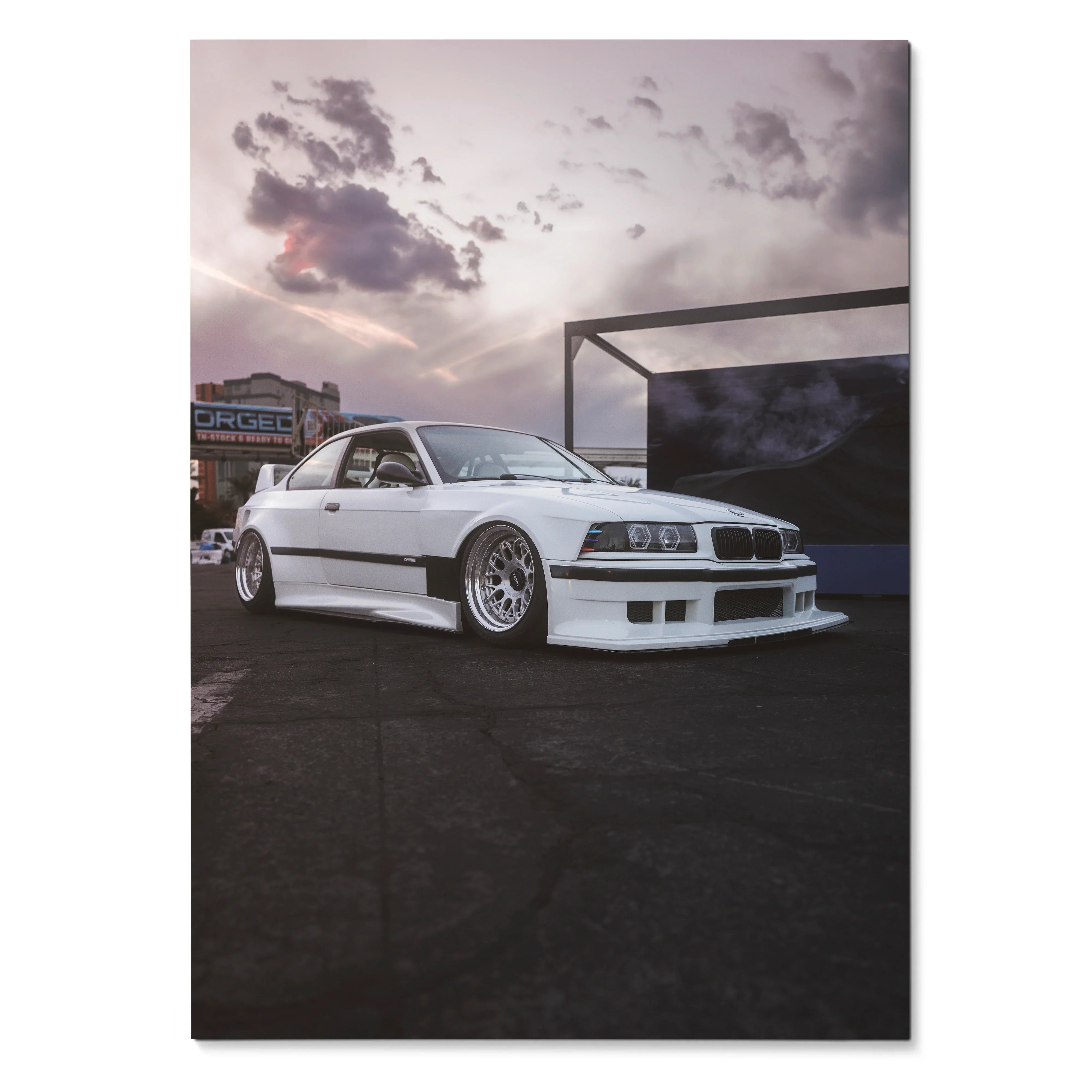 White BMW E36 M3 with lowered stance against dramatic cloudy sky poster wall art.