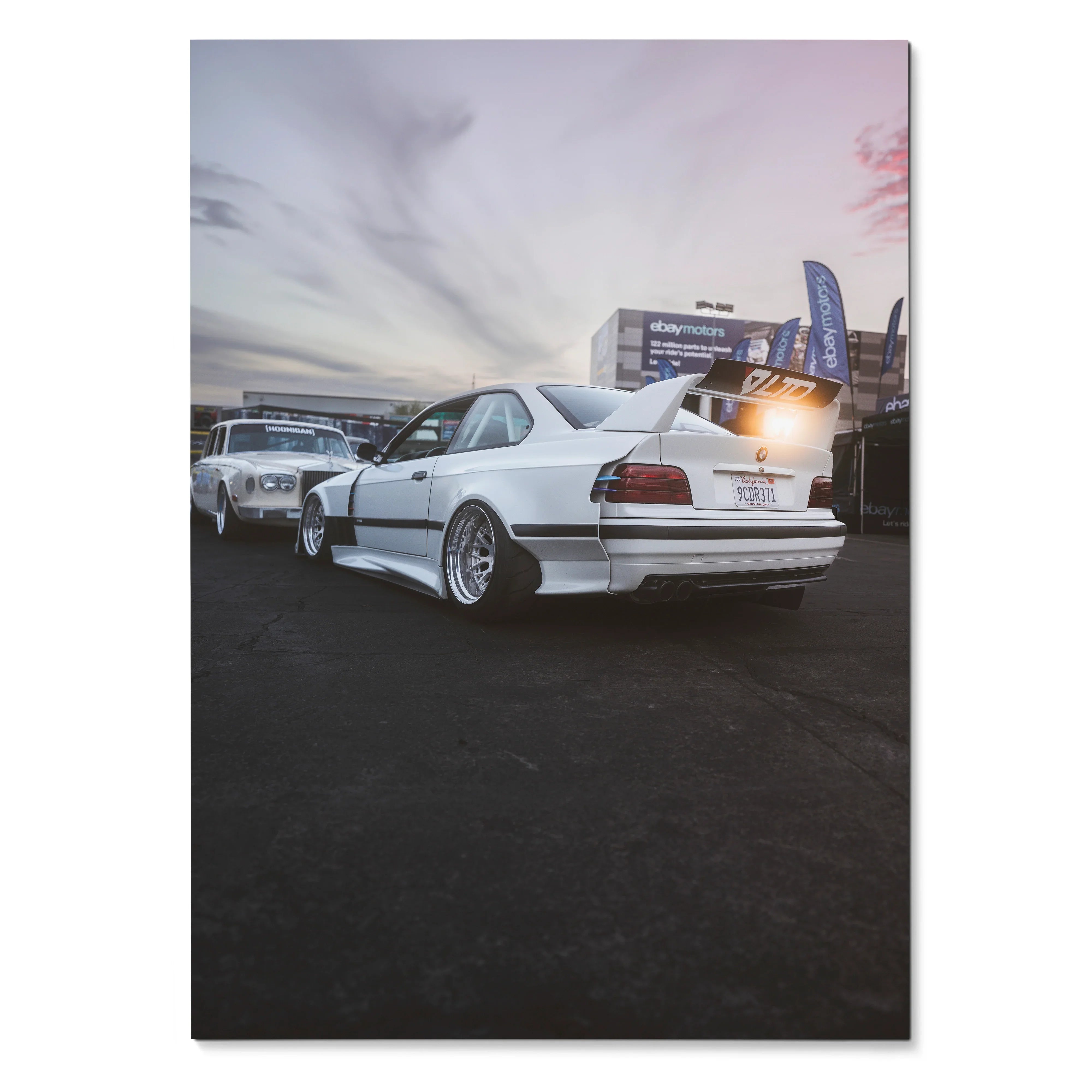 BMW E36 M3 widebody in white with lowered stance under a cloudy sky poster wall art.