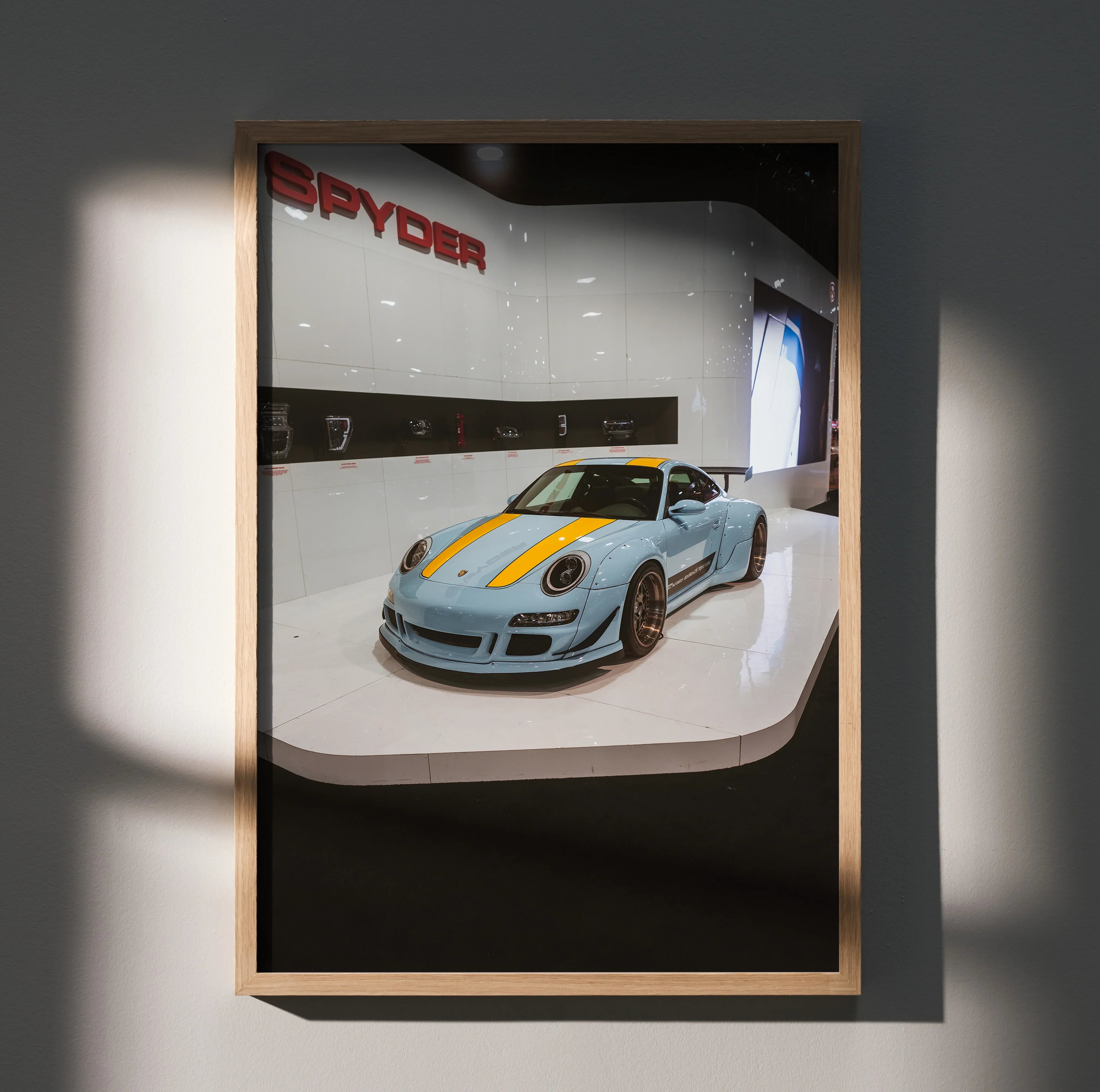 Porsche 911 Carrera 4 sports car with yellow racing stripes, displayed as high-resolution wall art poster in wooden frame.
