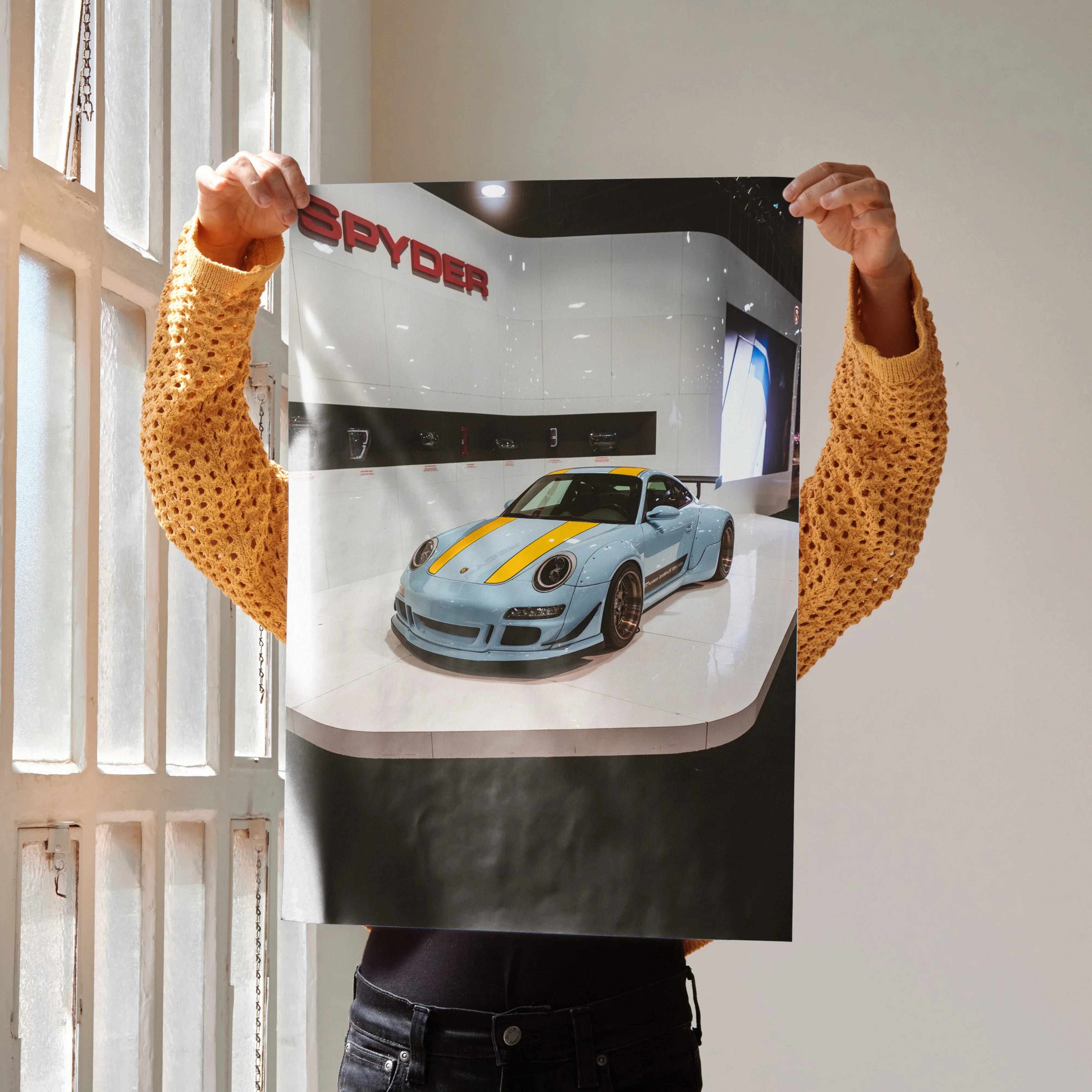 Porsche 911 Carrera 4 wall art poster with blue sports car and yellow racing stripes on gray background.