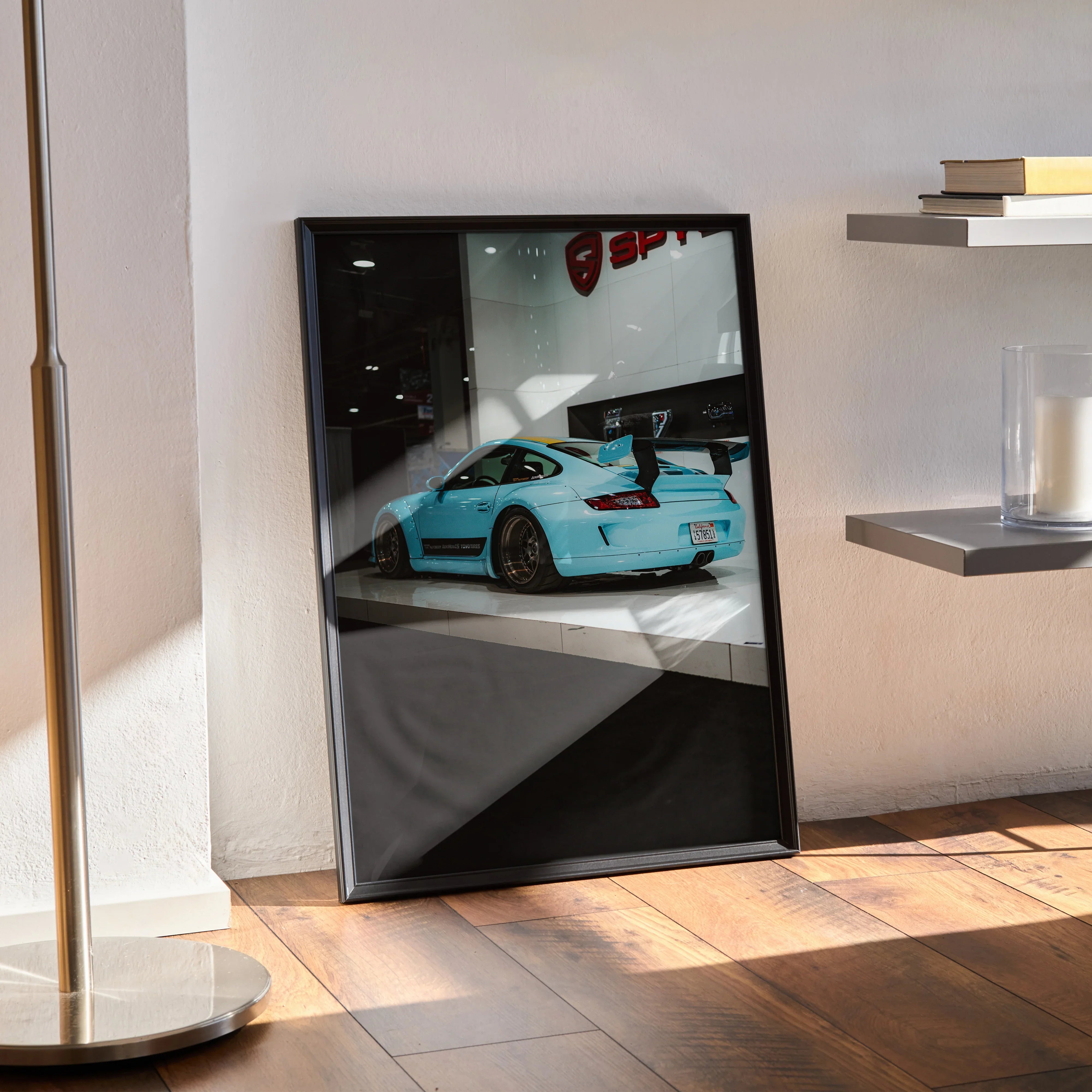 Framed Porsche 911 Carrera 4 wall art poster with turquoise car on glossy black background.