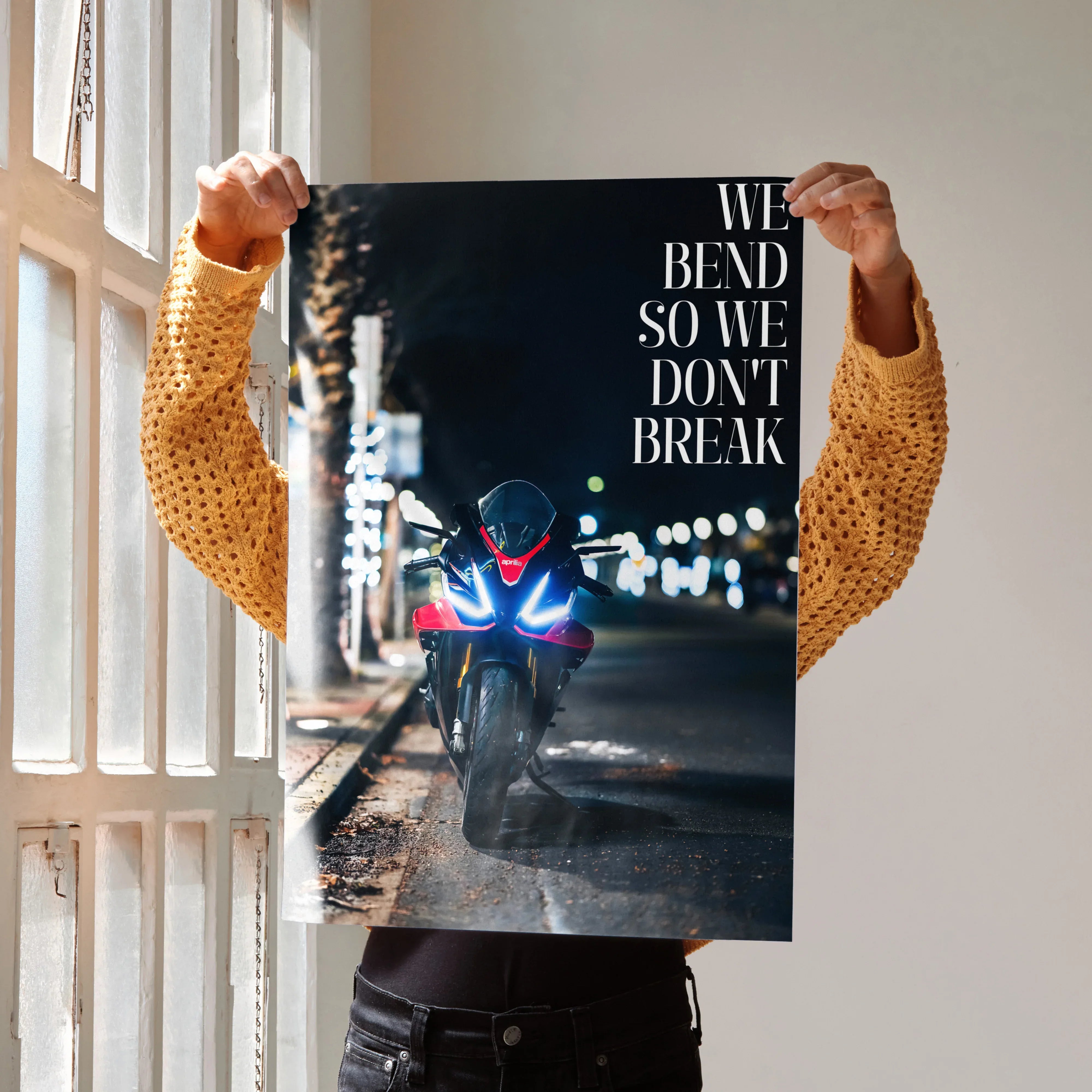 Motivational poster featuring Aprilia RSV4 1100 Factory motorcycle with "We Bend So We Don’t Break" quote at night wall art.