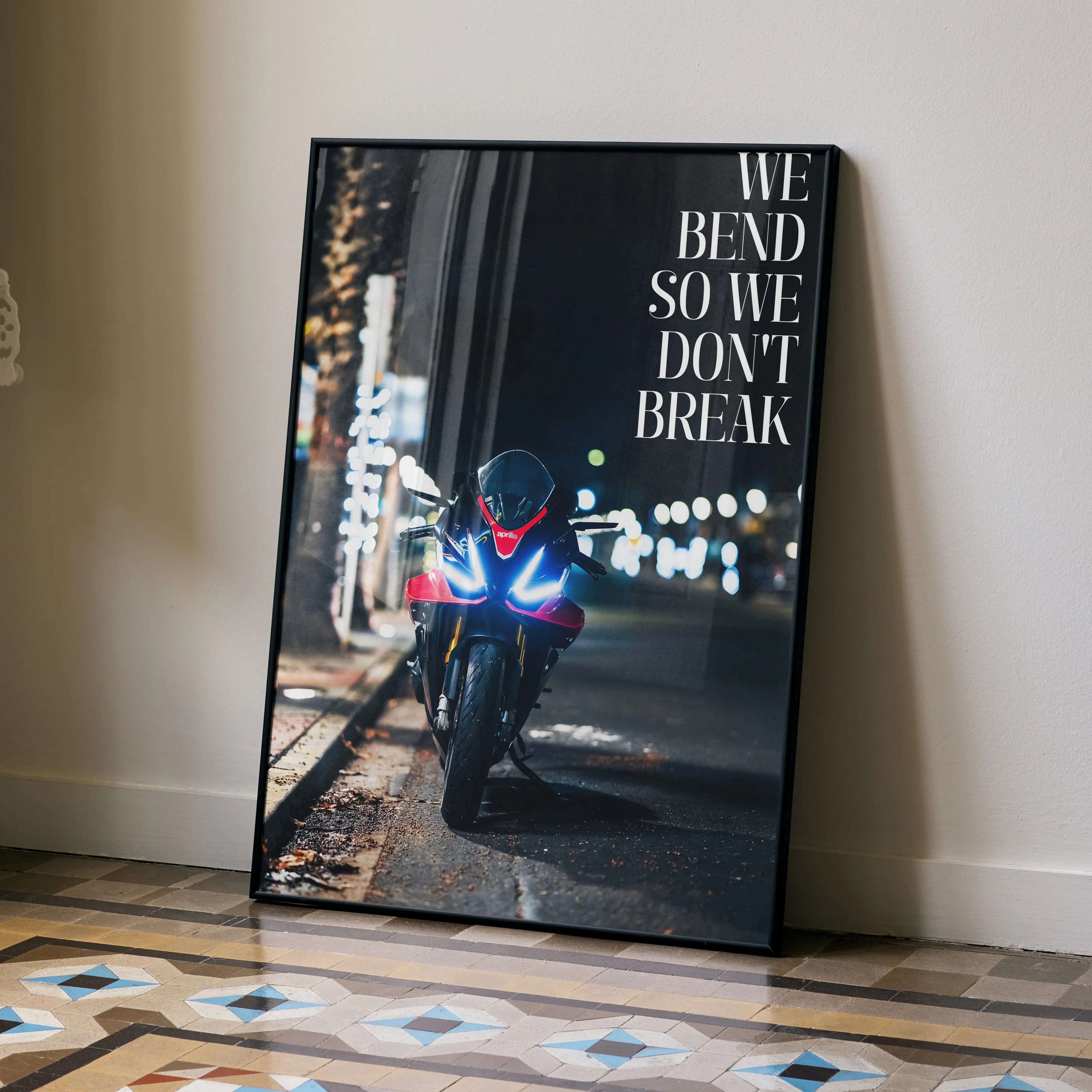 Motivational poster with Aprilia RSV4 1100 Factory motorcycle at night, wall art with quote "We bend so we don't break".
