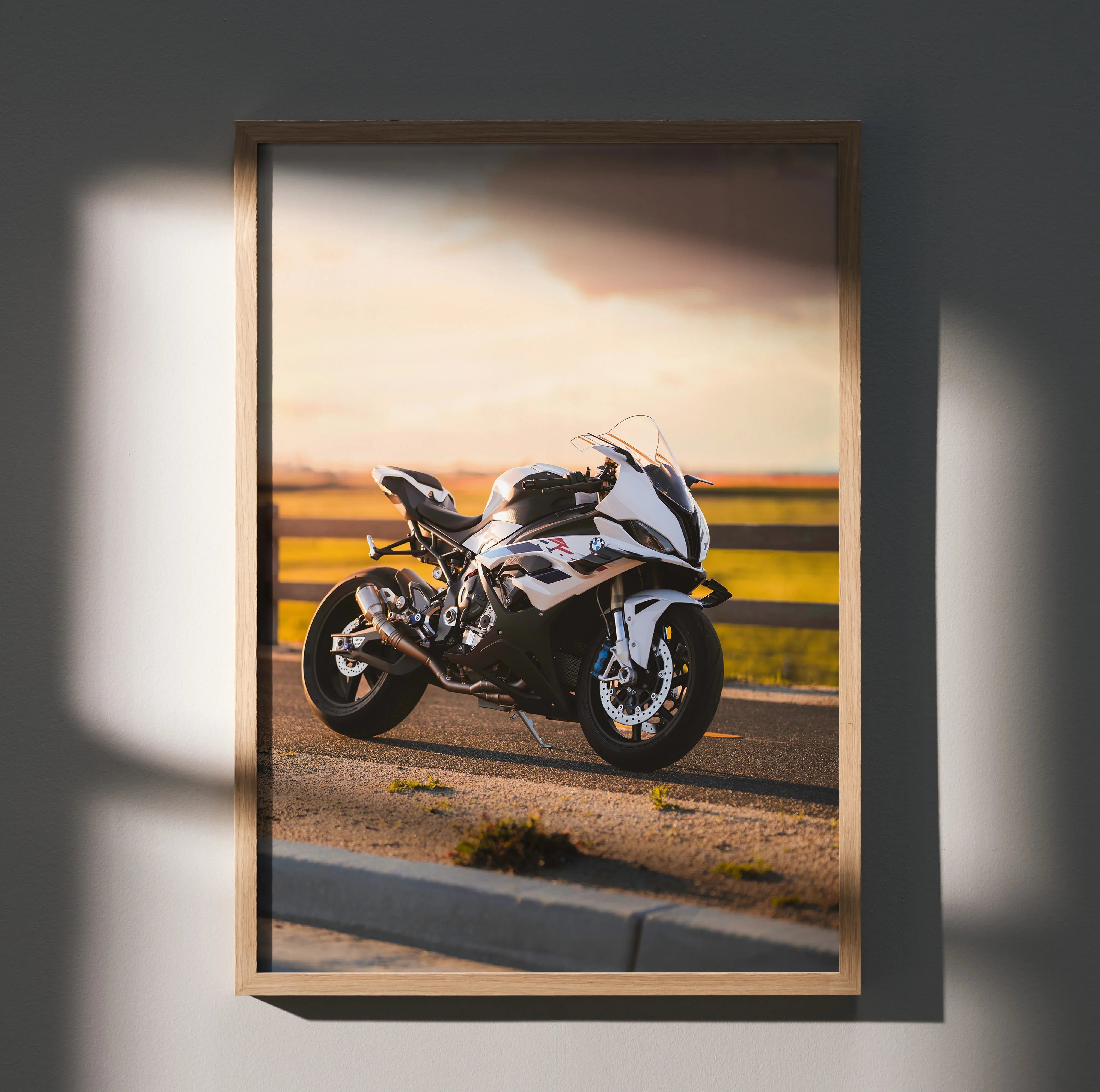 BMW S1000RR motorcycle poster with sunset background, premium wall art in wooden frame.