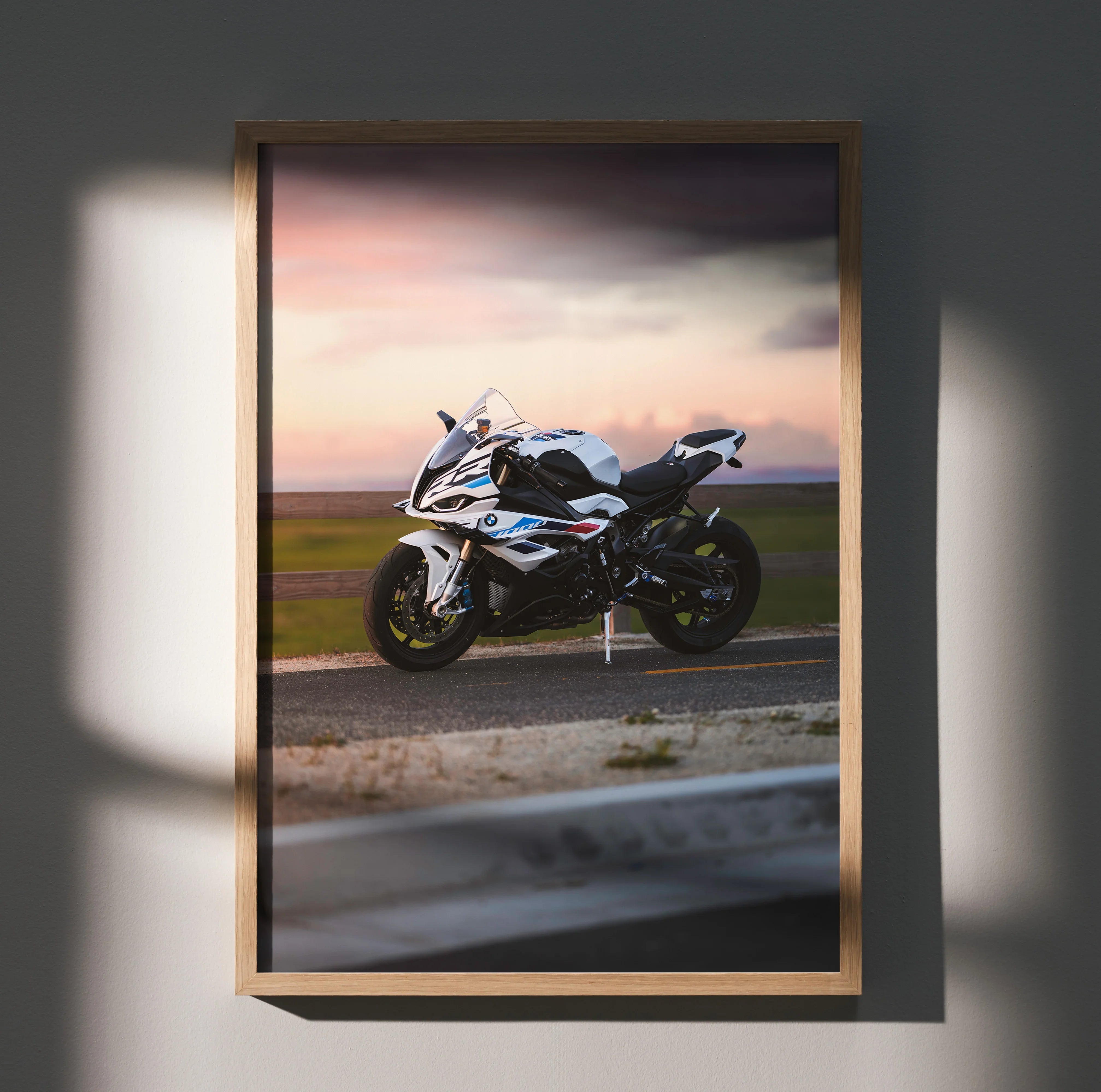 BMW S1000RR motorcycle poster wall art at sunset with sleek white bike and dynamic sky.