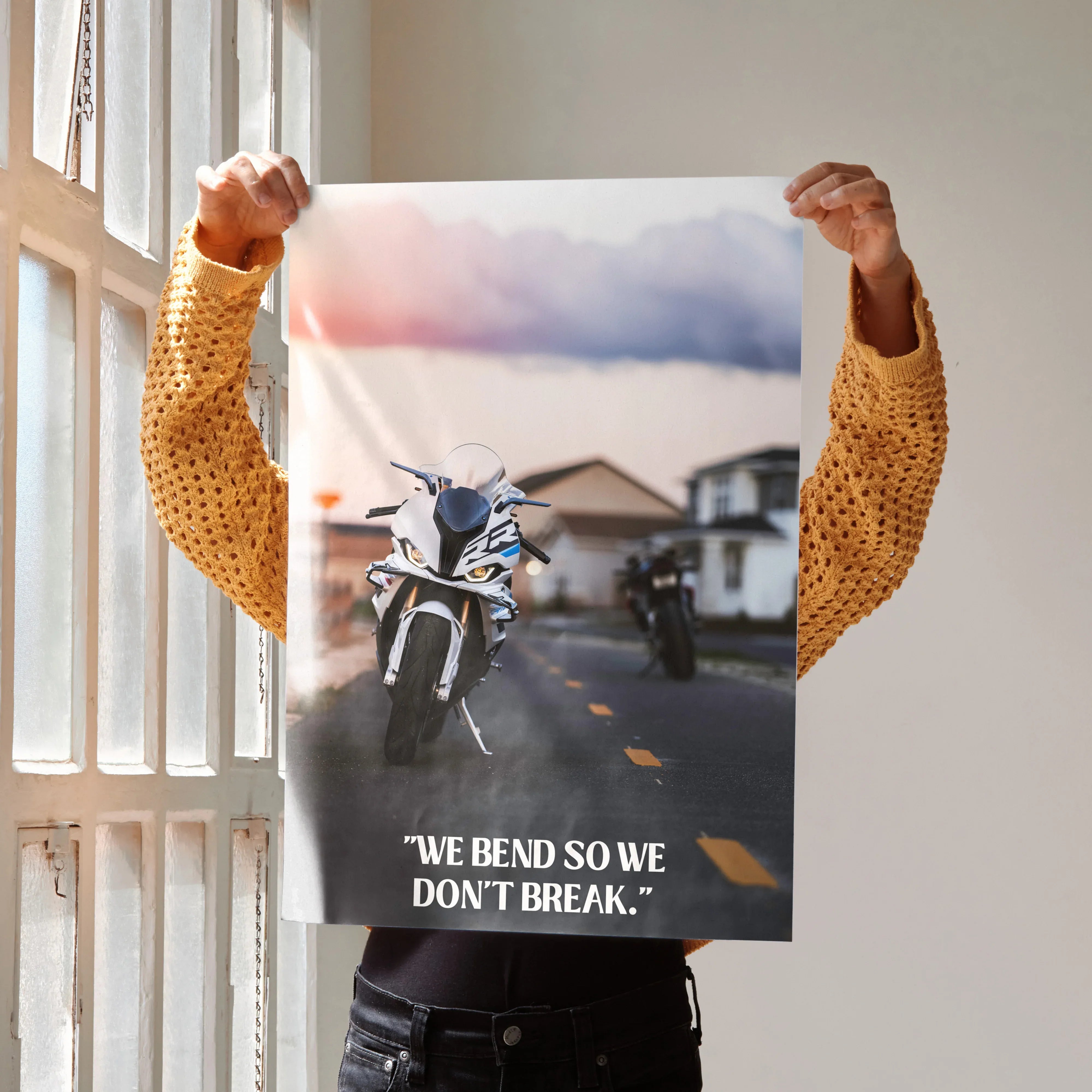 Motivational poster wall art featuring BMW S1000RR motorcycle with inspiring text "We bend so we don't break".