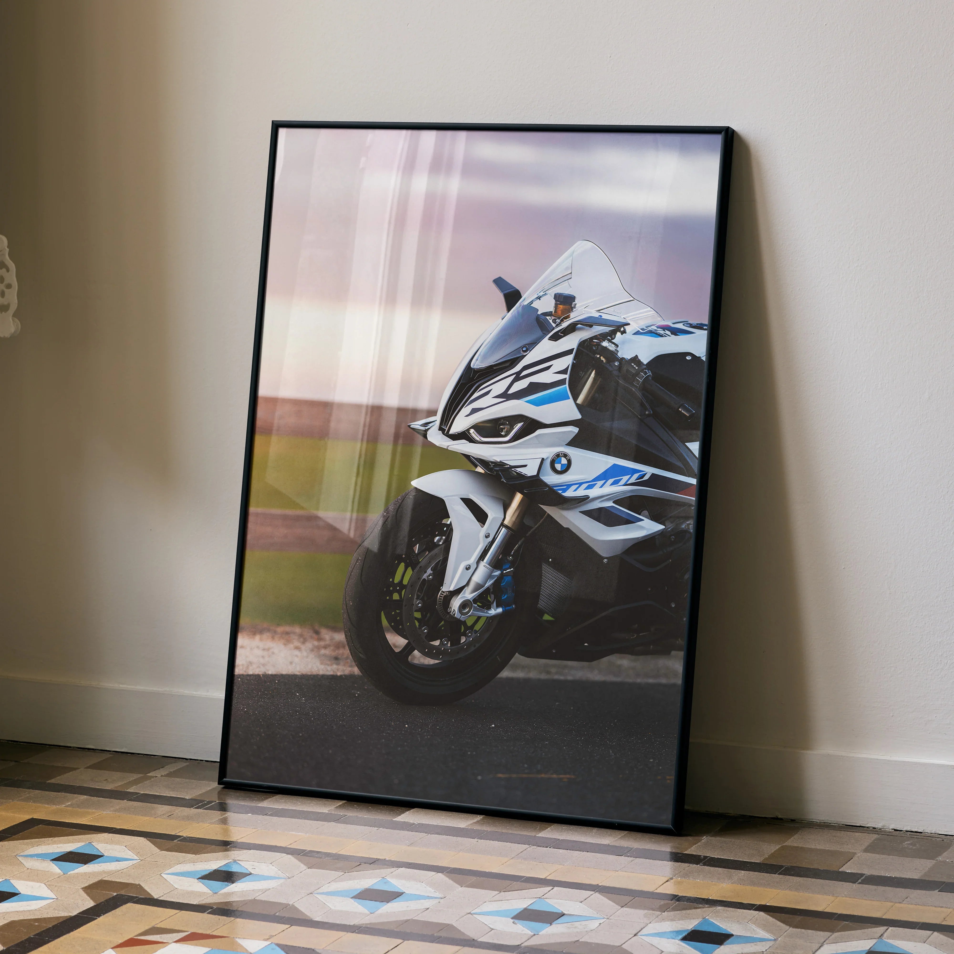BMW S1000RR motorcycle poster in black frame leaning against wall, sleek racing bike wall art.