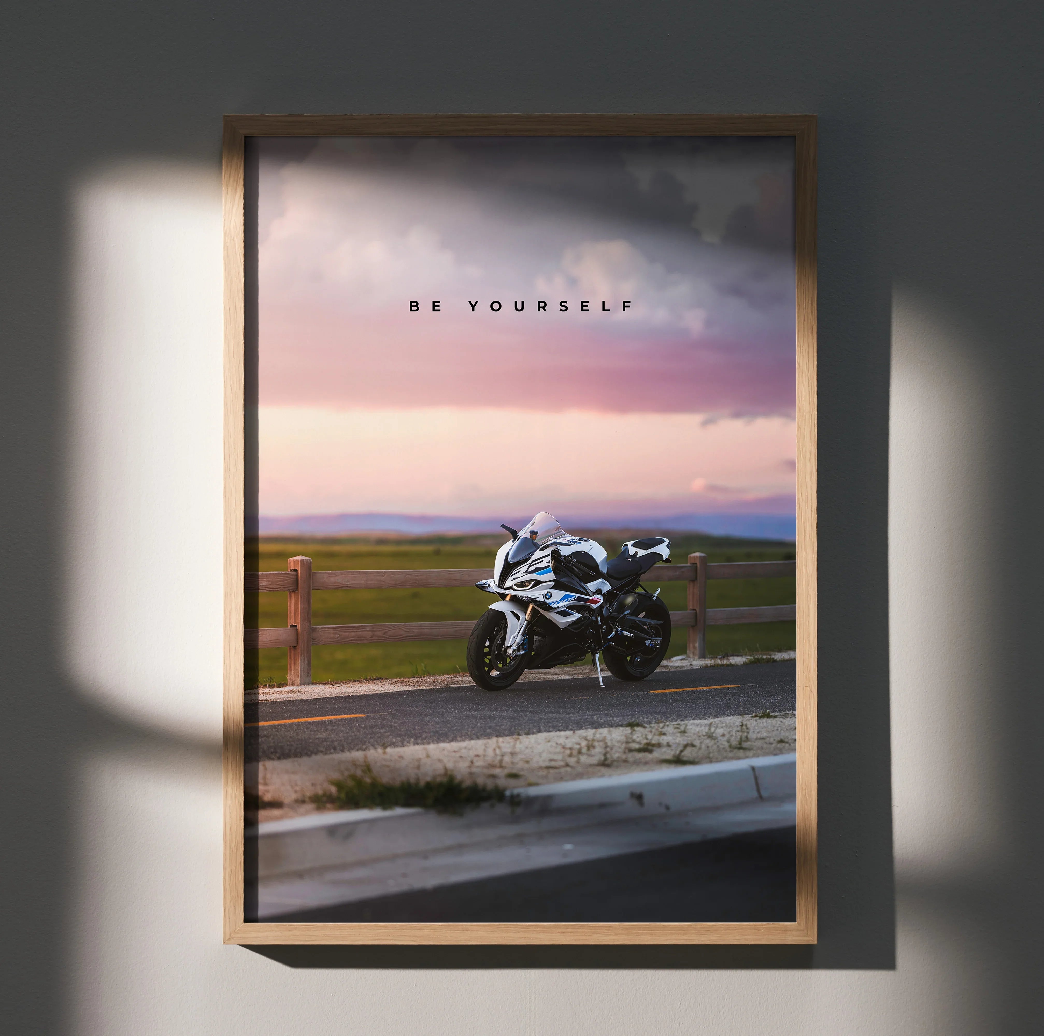 Motivational poster wall art featuring a BMW S1000RR motorcycle with "Be Yourself" text at sunset.