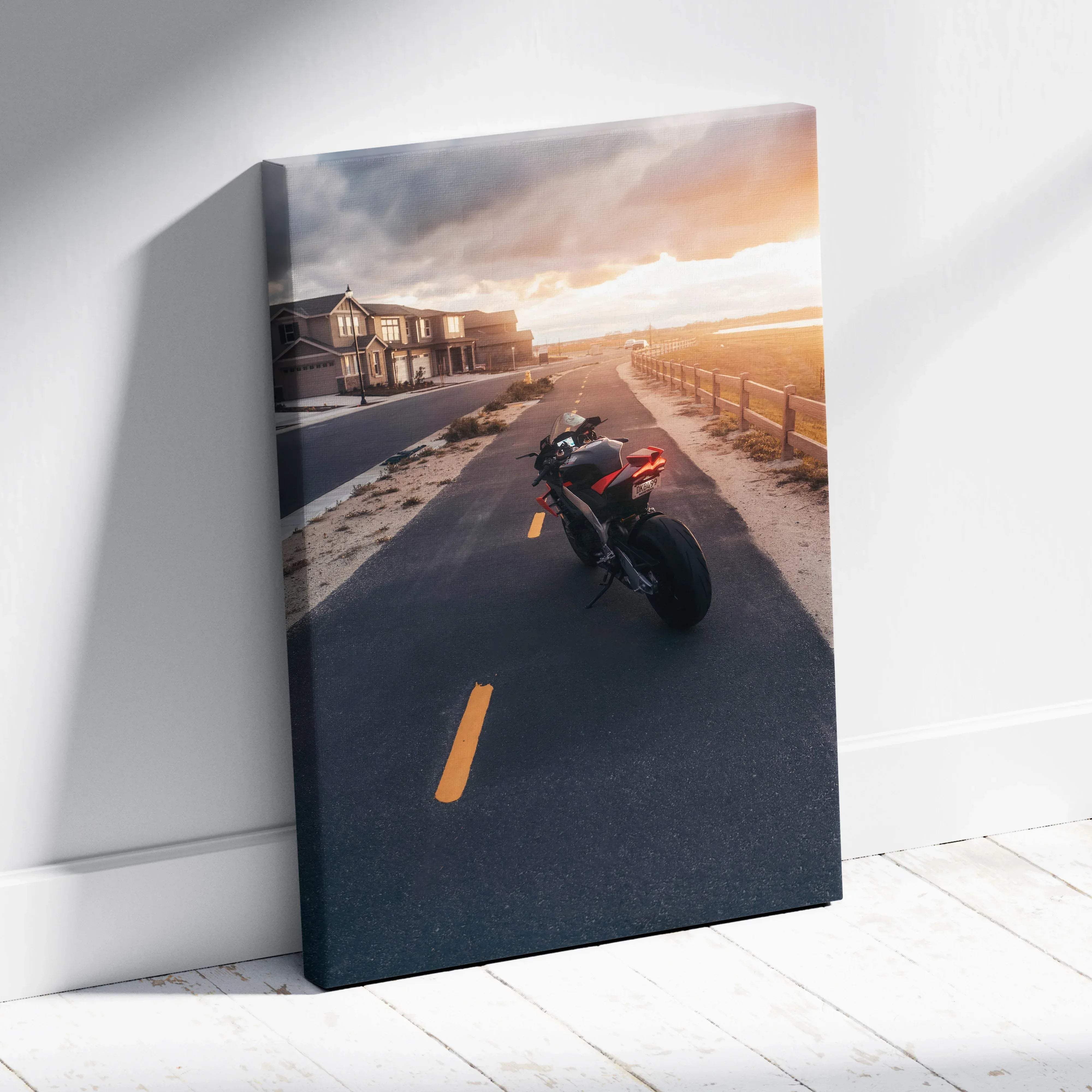 Canvas wall art featuring a black and red aprilia RSV4 1100 Factory sport motorcycle leaning against a white wall