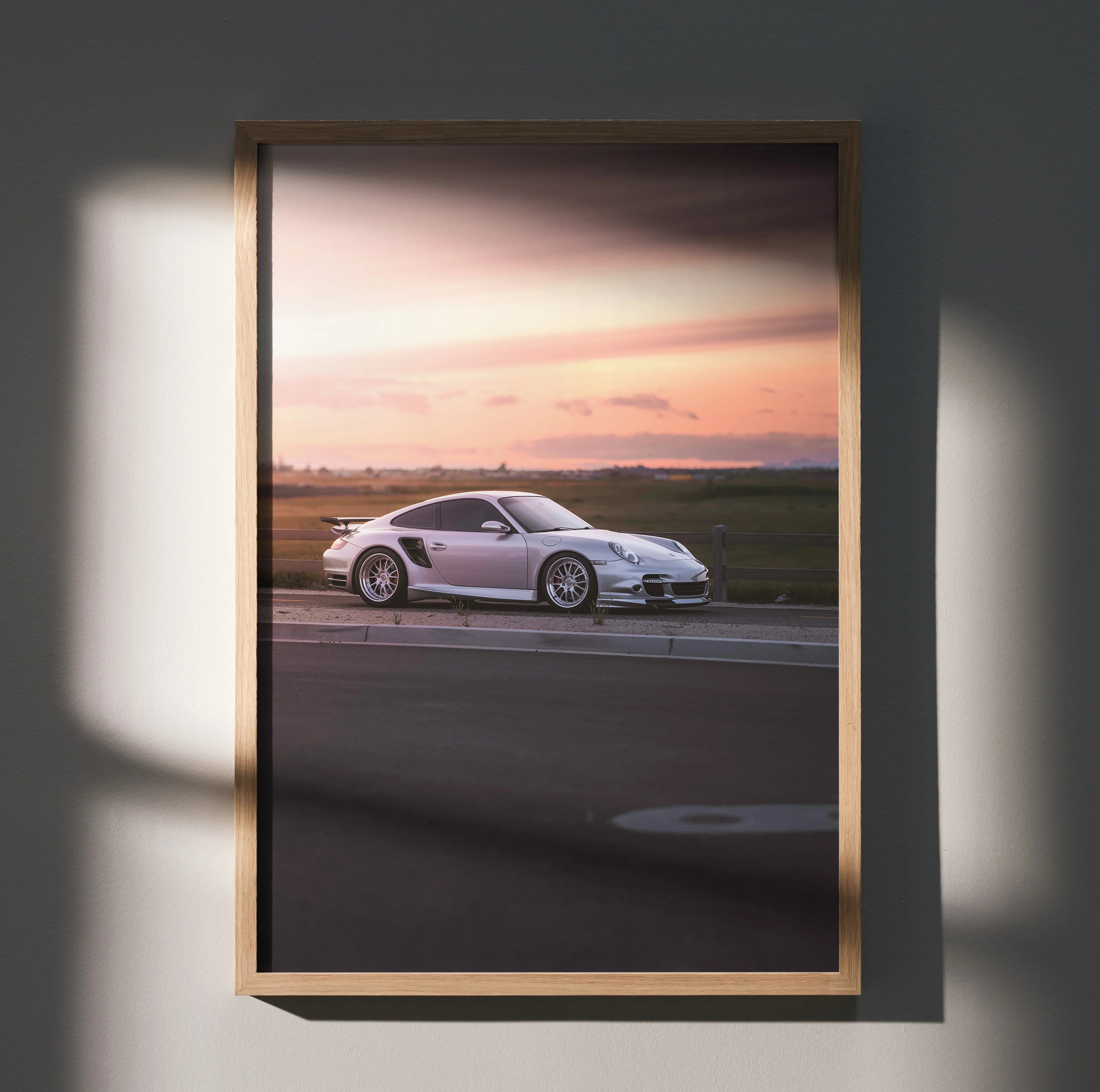 Porsche 911 Turbo poster wall art with silver sports car and sunset sky in wooden frame.