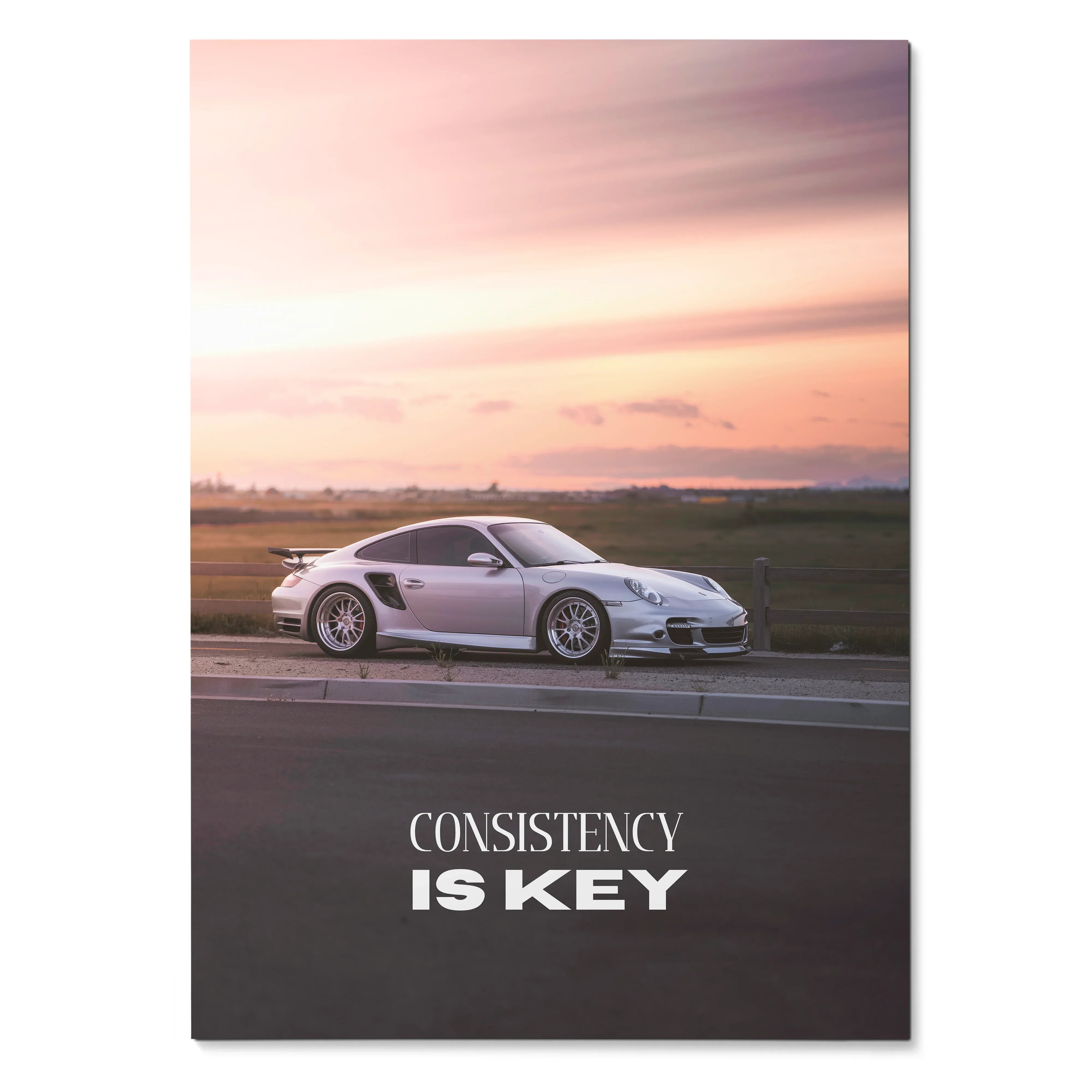 Poster wall art featuring a white Porsche 911 Turbo at sunset with "Consistency is Key" text.