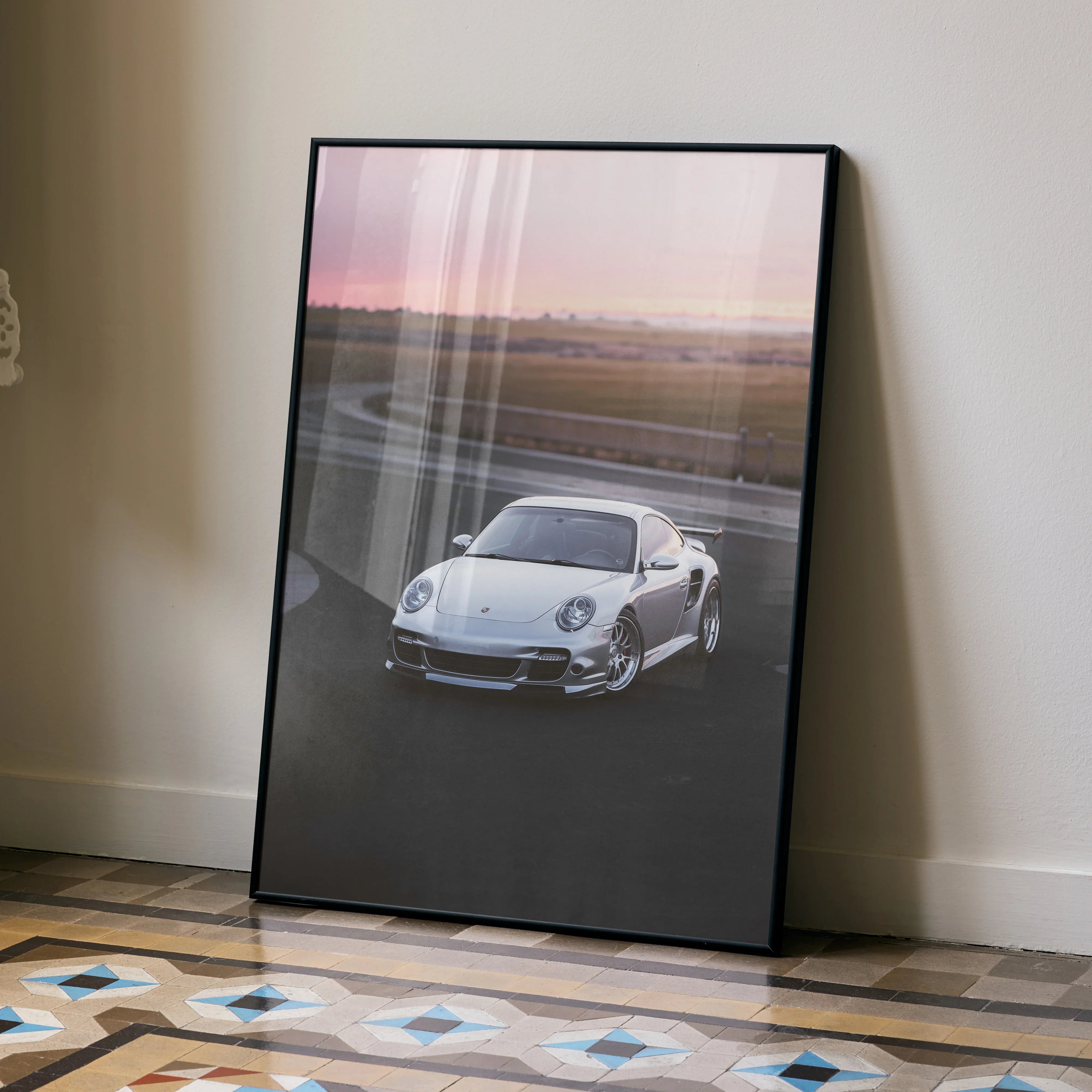 Porsche 911 Turbo poster showcasing a silver sports car at sunset, high-resolution wall art.