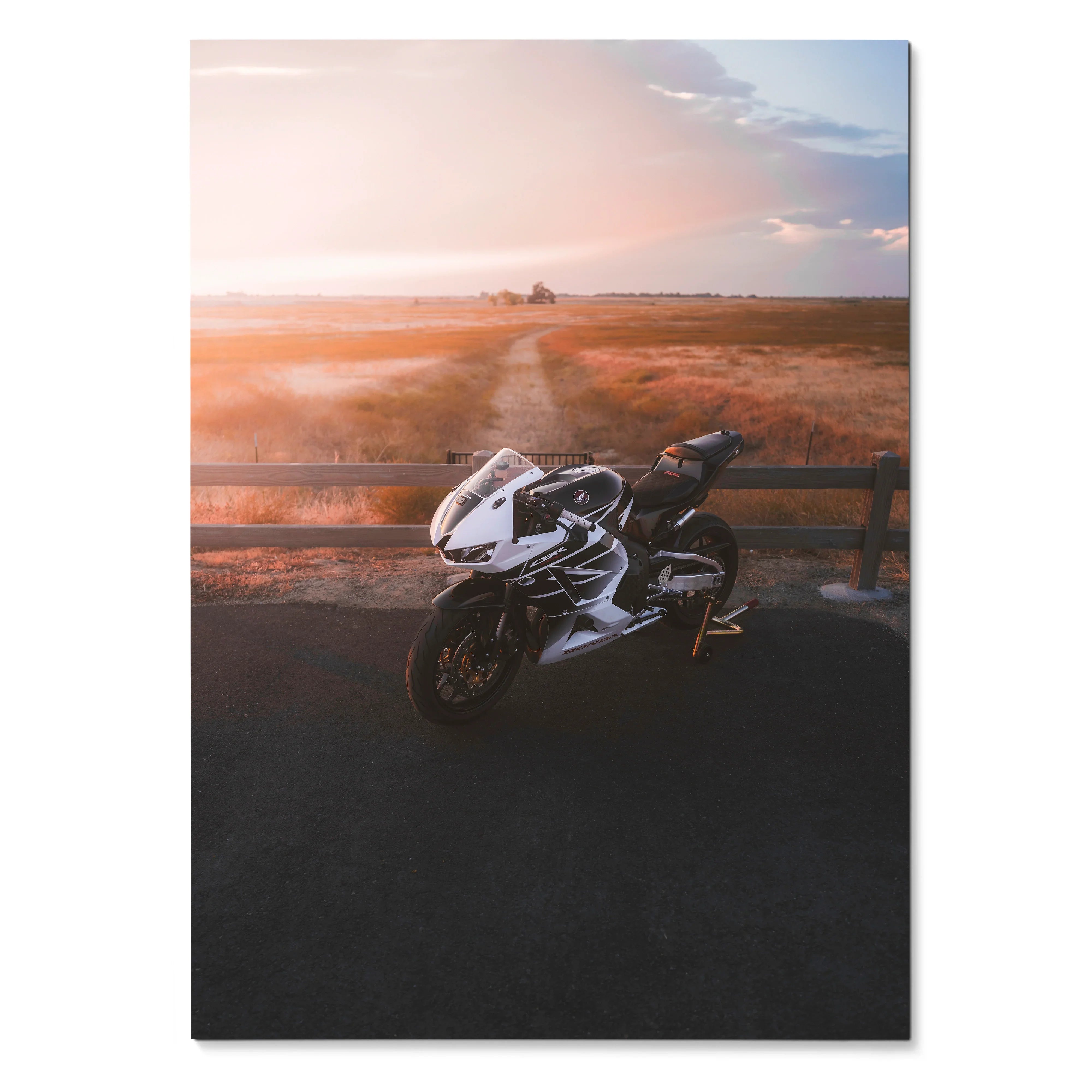 Honda CBR600RR motorcycle parked at sunset on road with warm sky poster wall art.