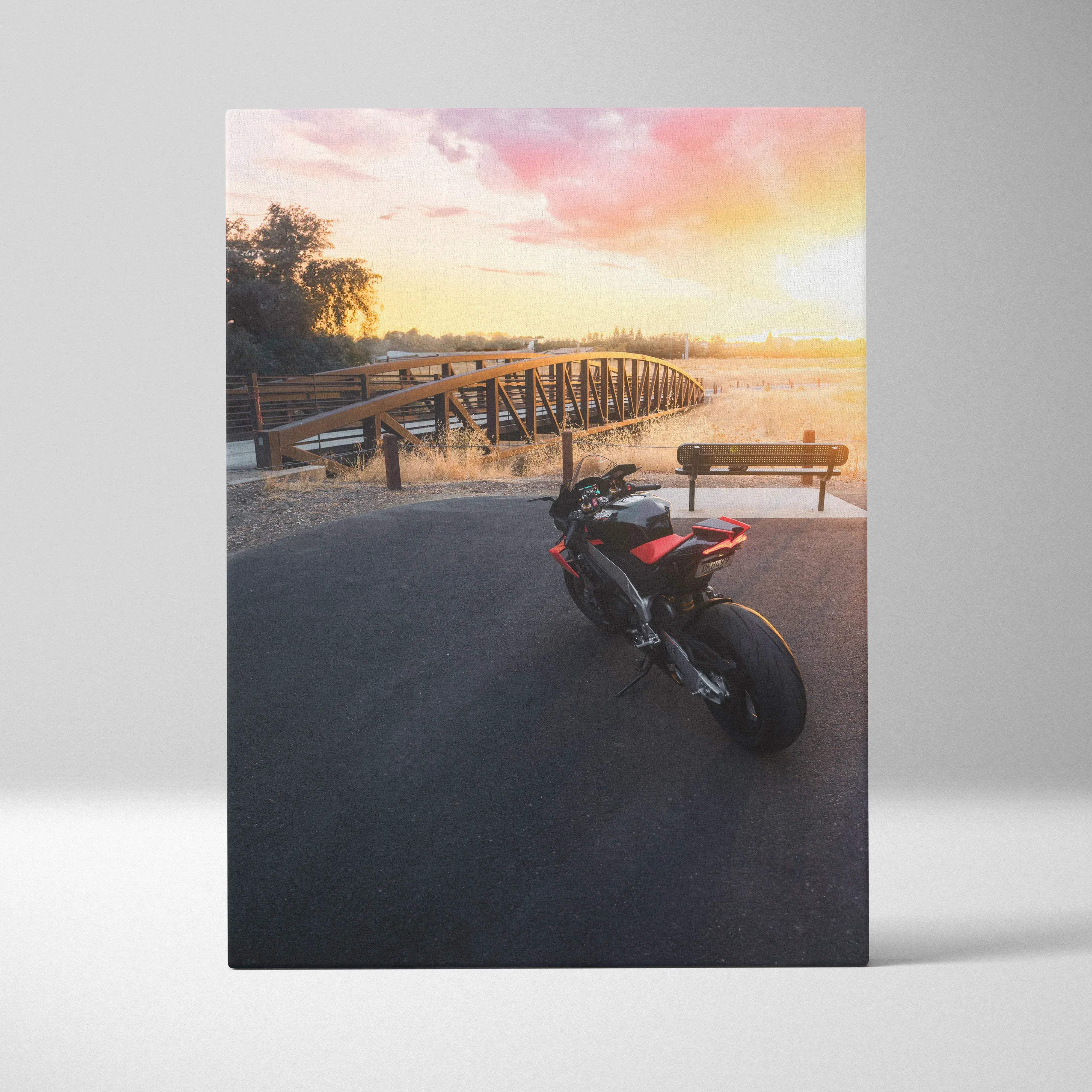 Canvas wall art vertical print of black and red aprilia rsv4 1100 factory motorcycle under warm sunset sky