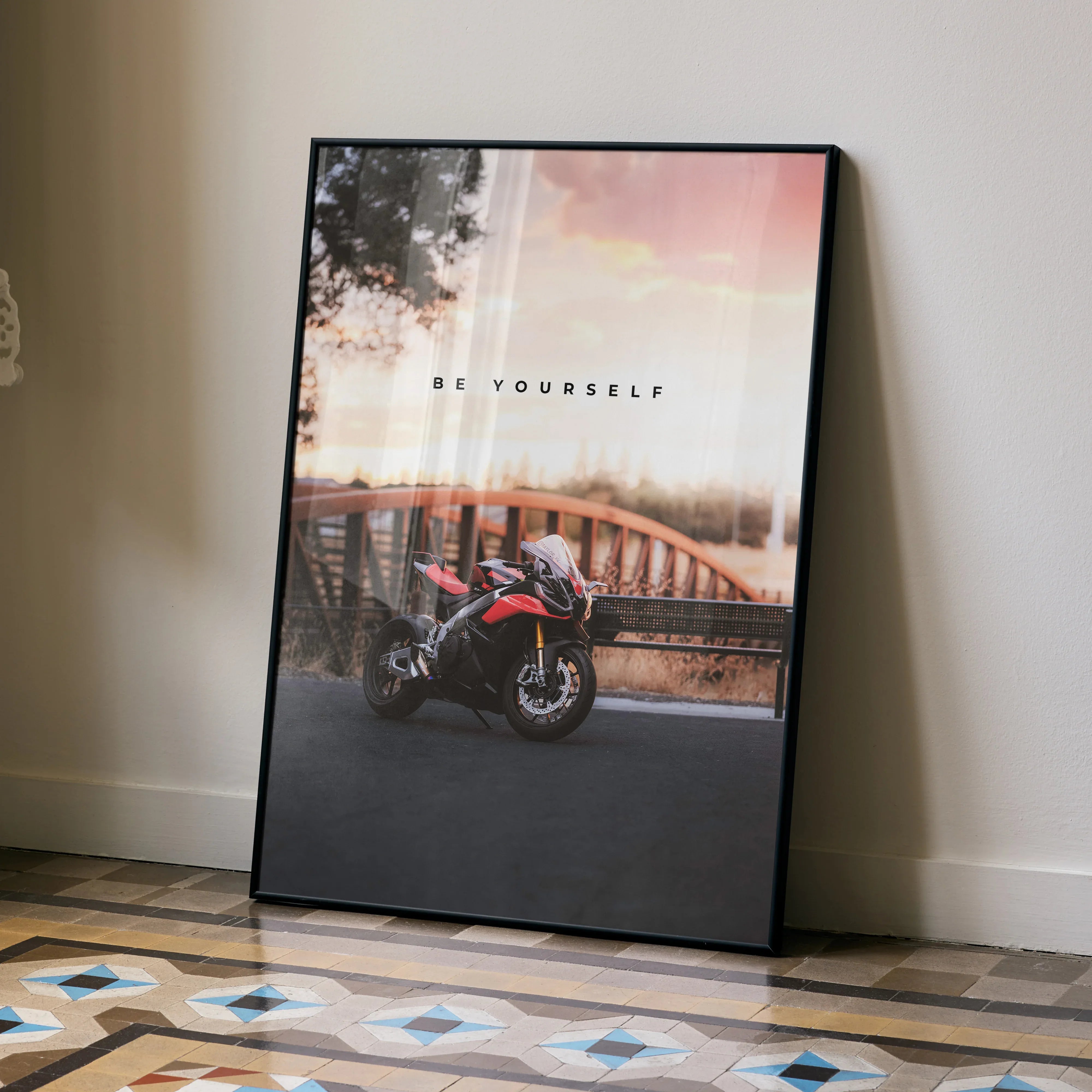 Motivational poster wall art featuring Aprilia RSV4 1100 Factory motorcycle by a bridge at sunset.
