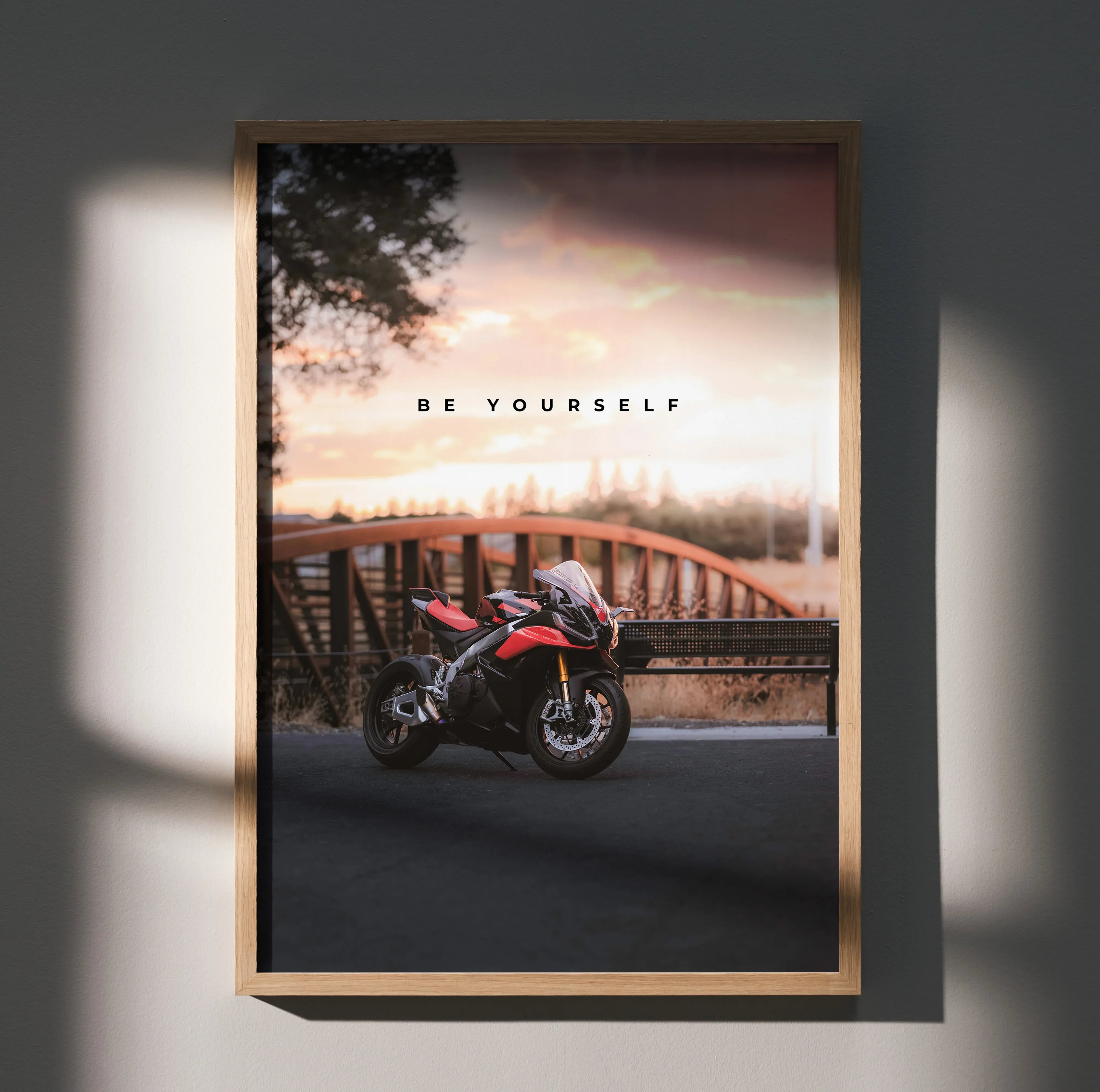 Motivational poster wall art featuring Aprilia RSV4 1100 Factory motorcycle at sunset with "Be Yourself" text.