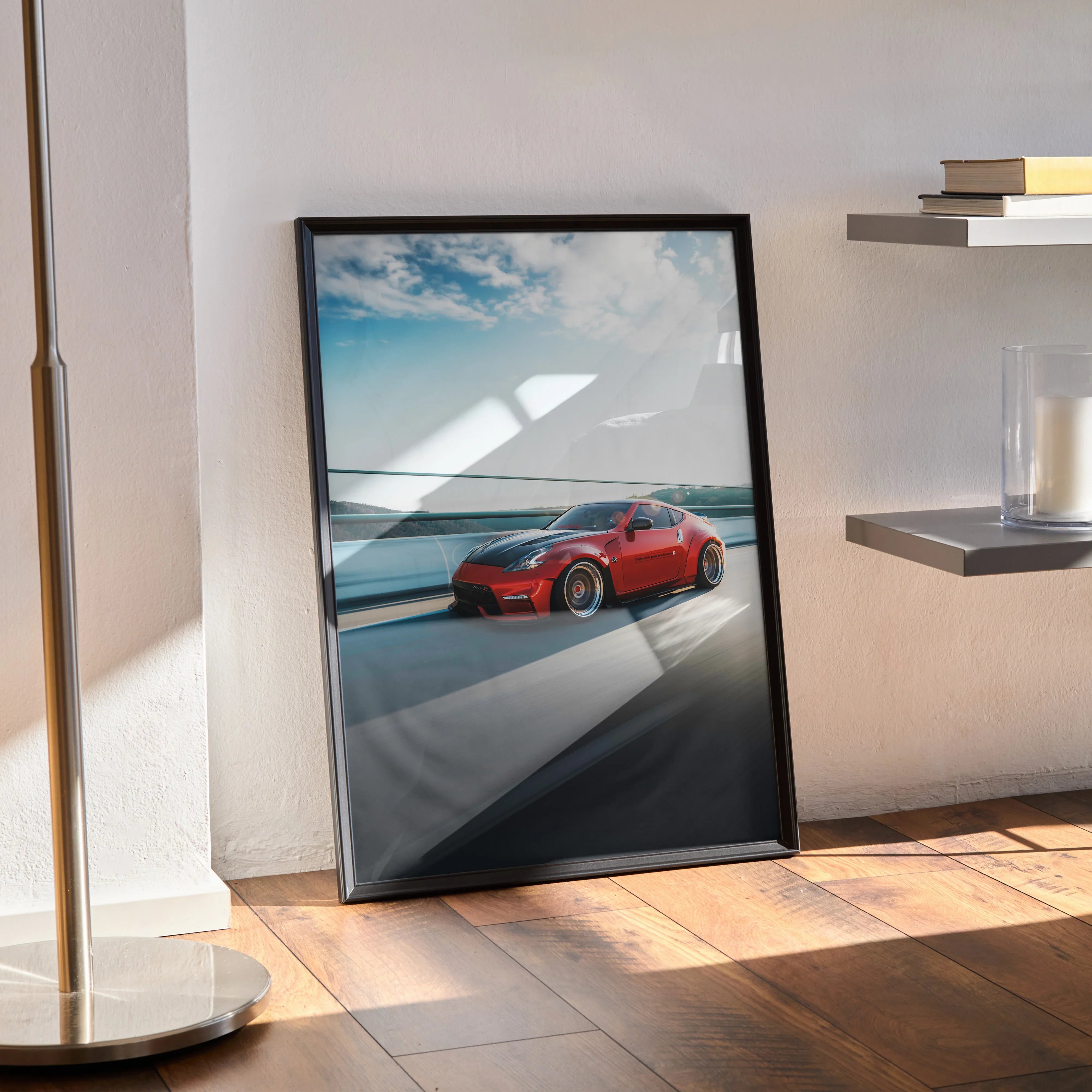 Nissan 370Z red sports car poster in black frame leaning on wall, modern automotive wall art.