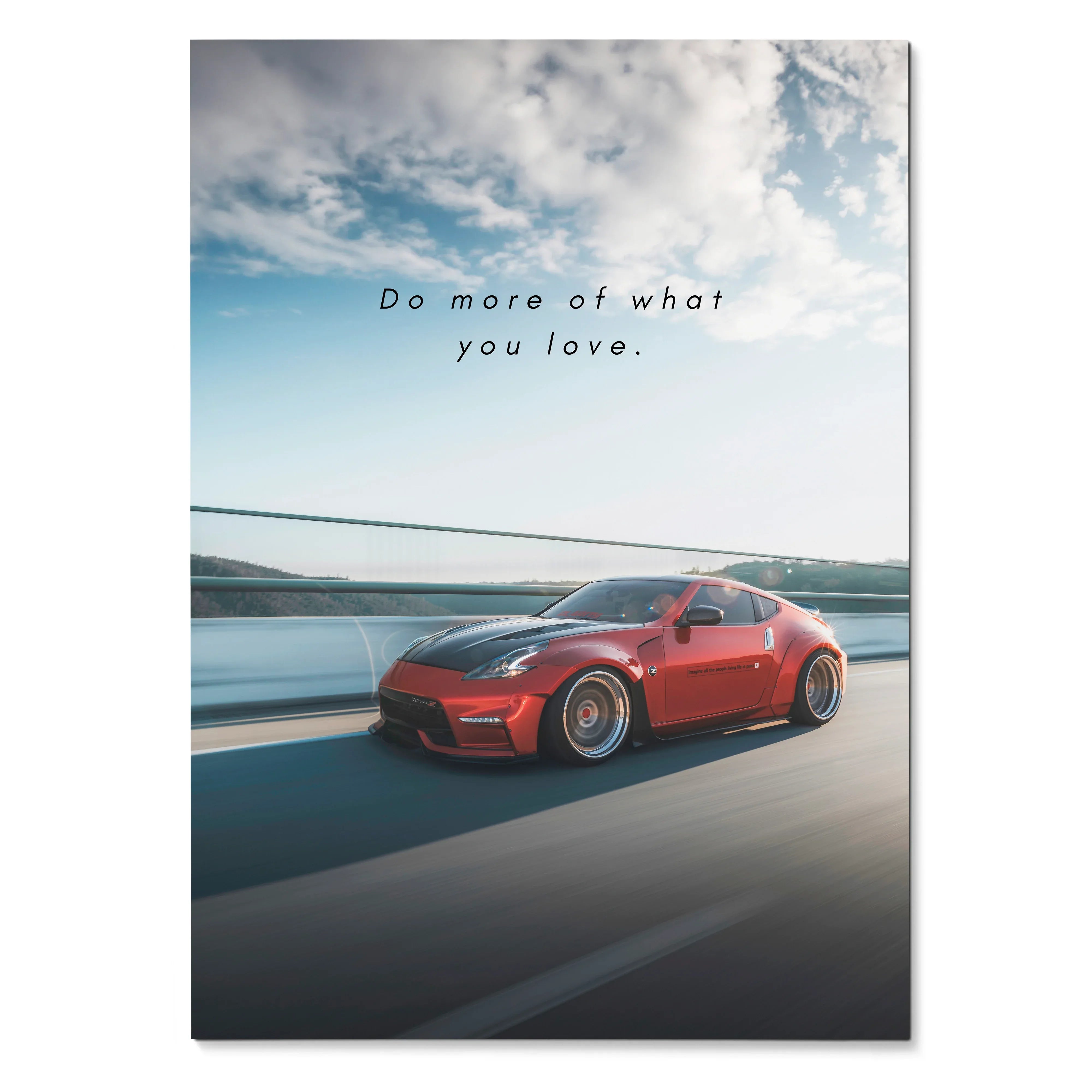 Motivational poster featuring a red Nissan 370z driving on highway under blue sky with inspiring text wall art.