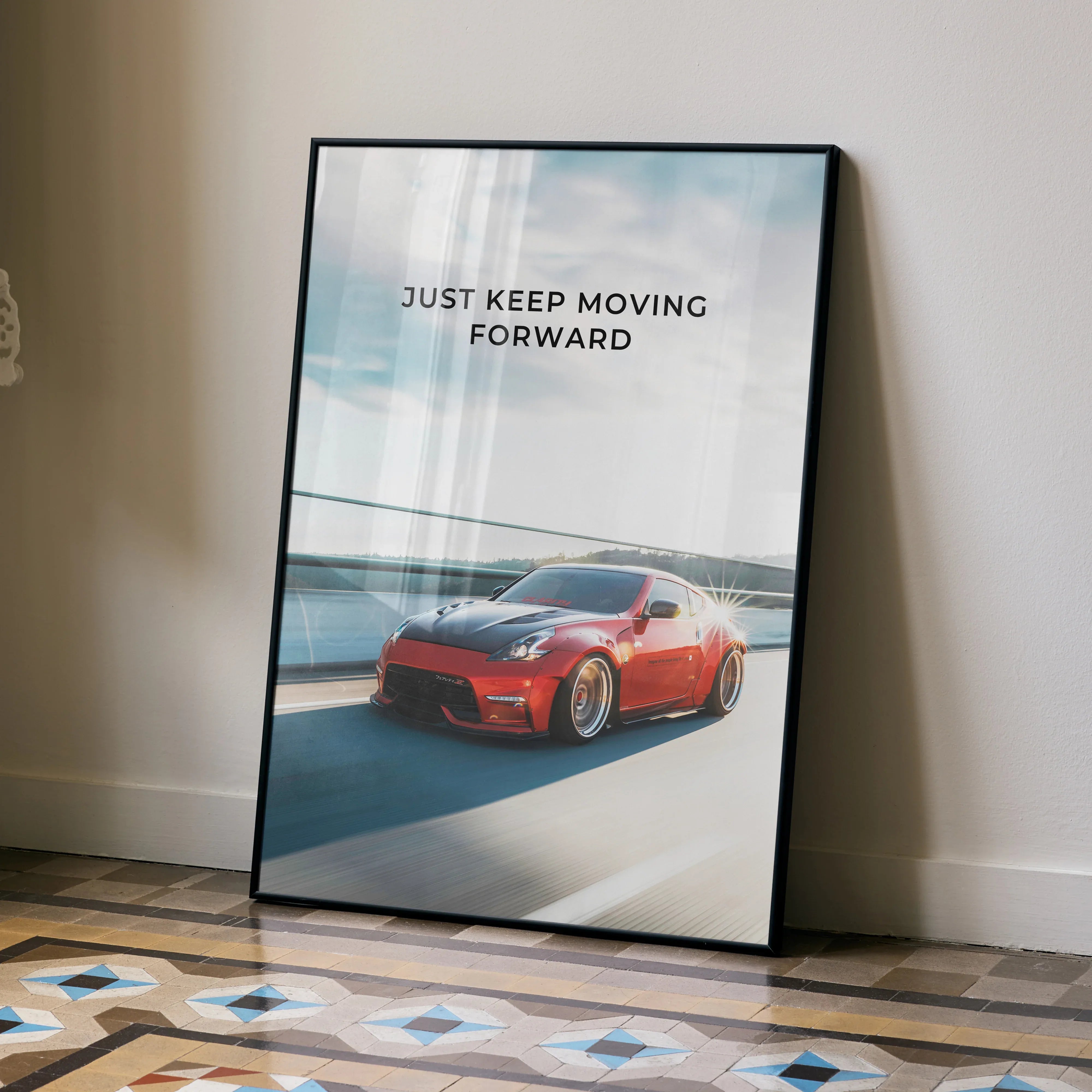 Motivational poster wall art featuring red Nissan 370z with inspiring text "Just Keep Moving Forward".