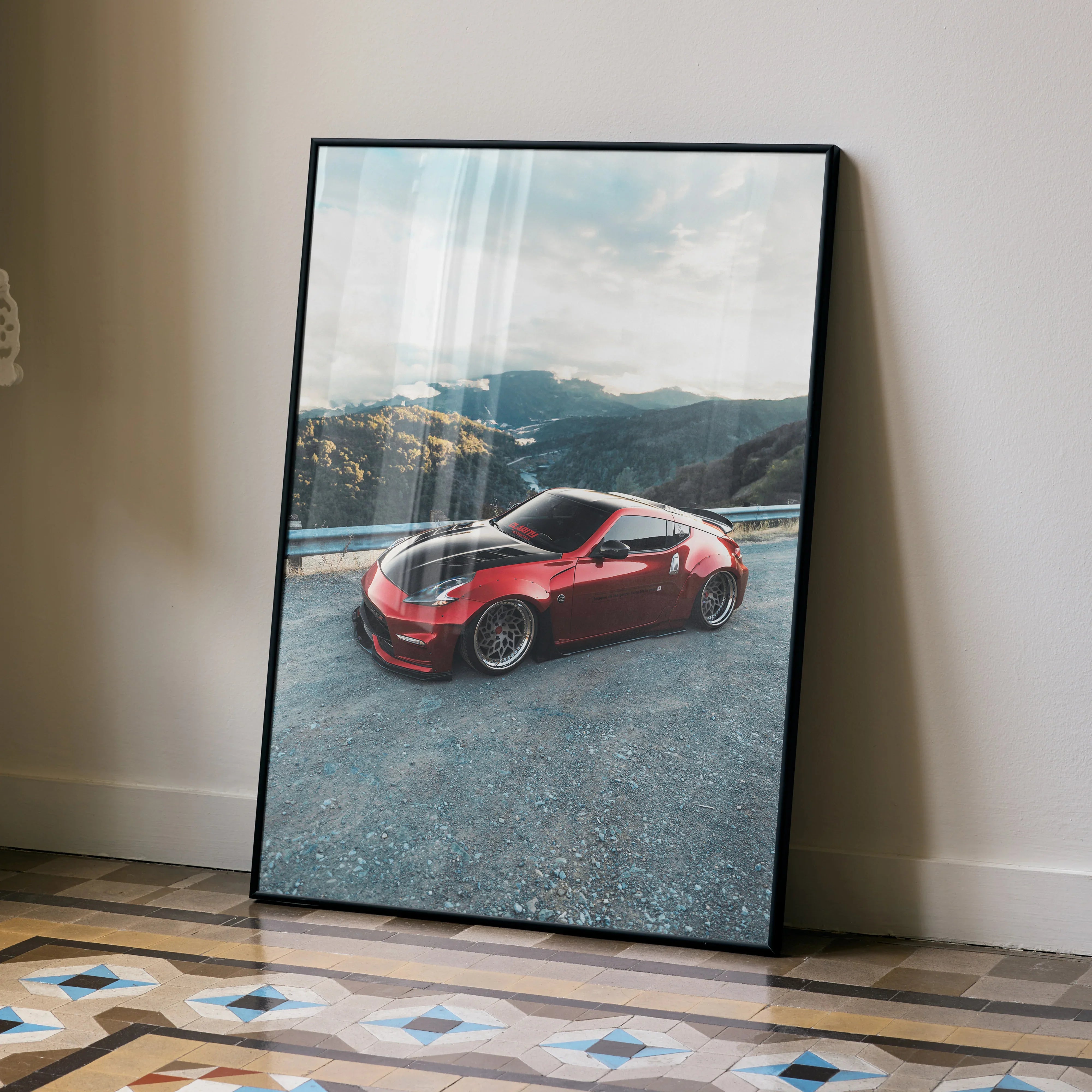 Nissan 370Z red sports car on mountain road poster wall art in black frame.