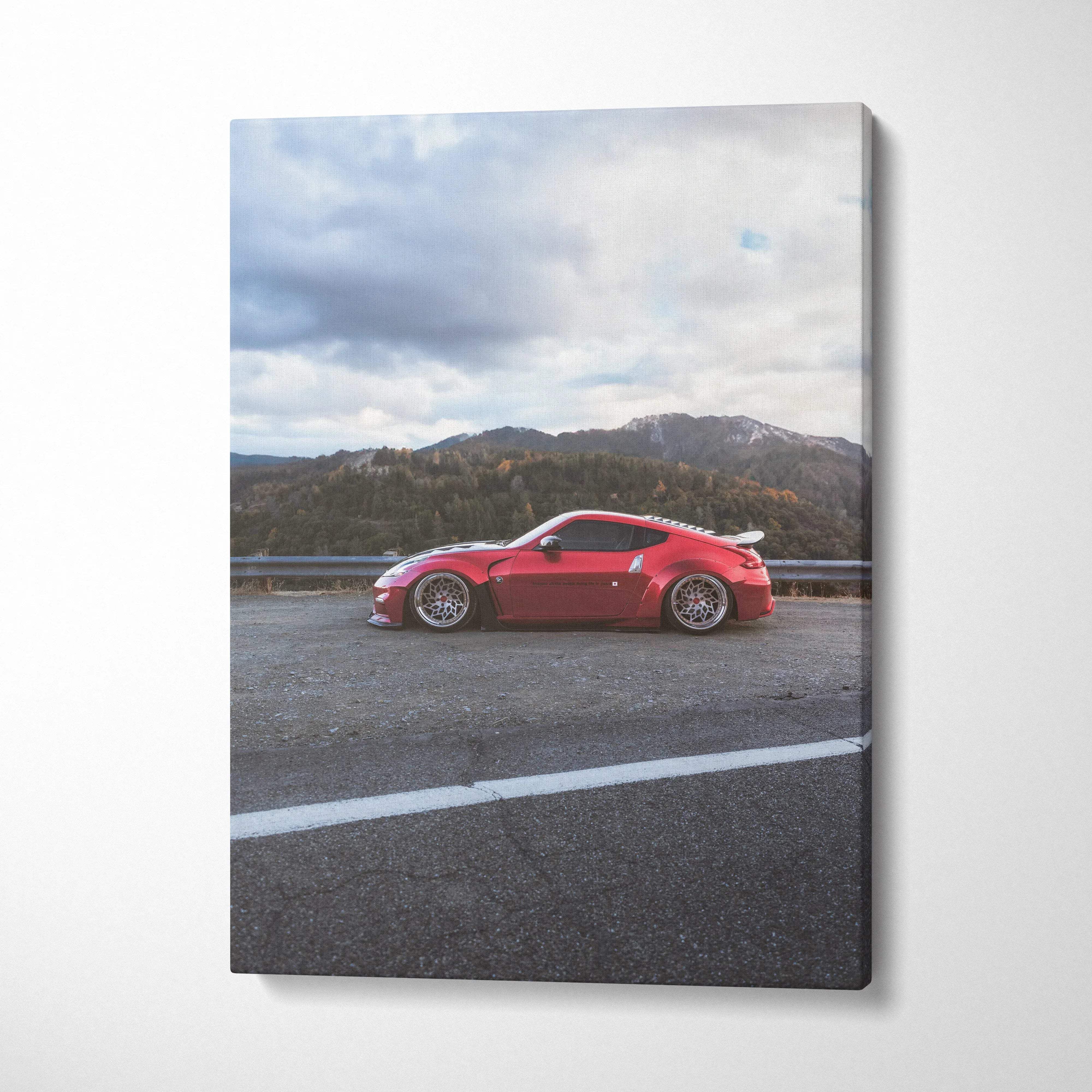Red Nissan 370z sports car on road with mountains backdrop vertical canvas wall art.