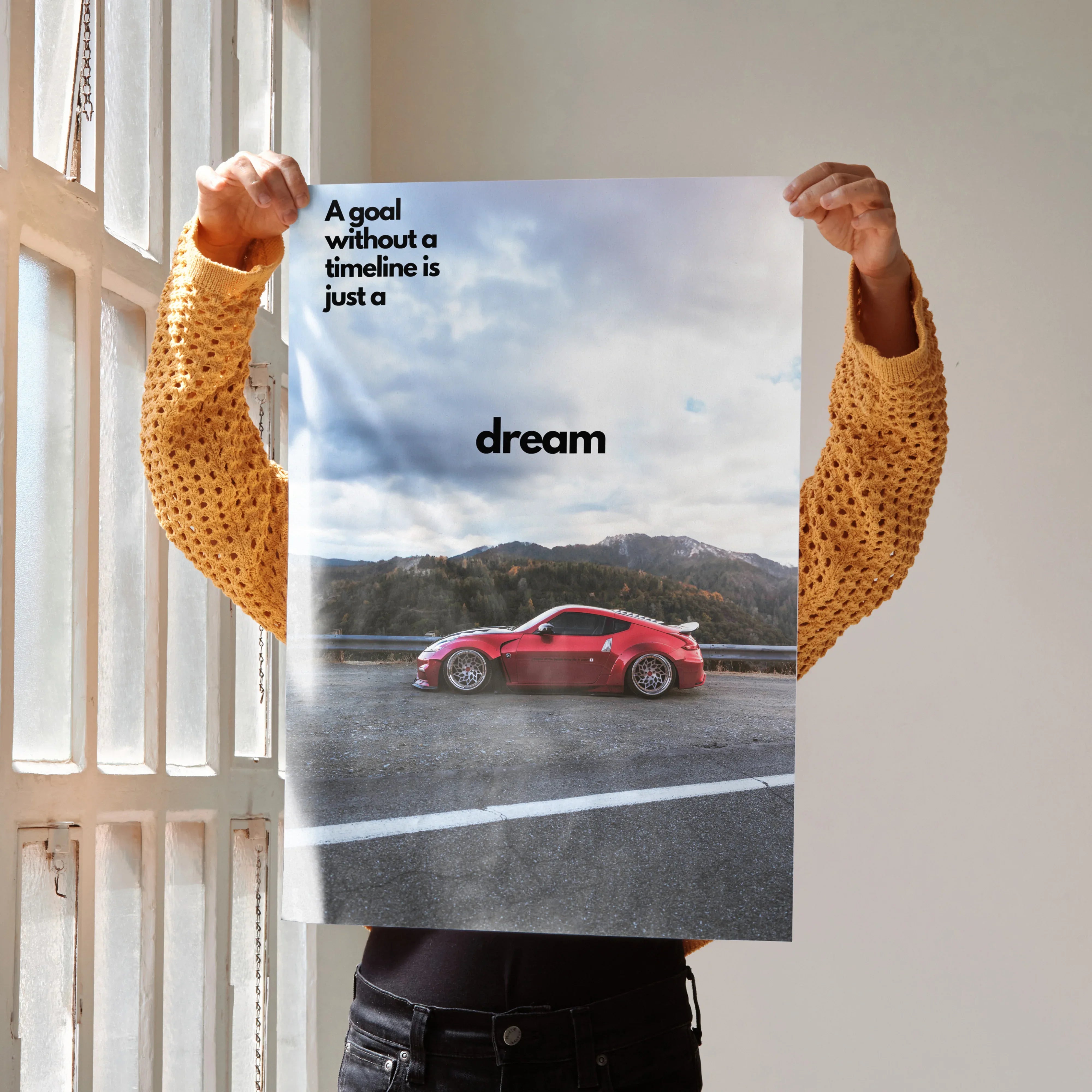 Motivational poster featuring red Nissan 370z on road with inspiring text dream wall art.