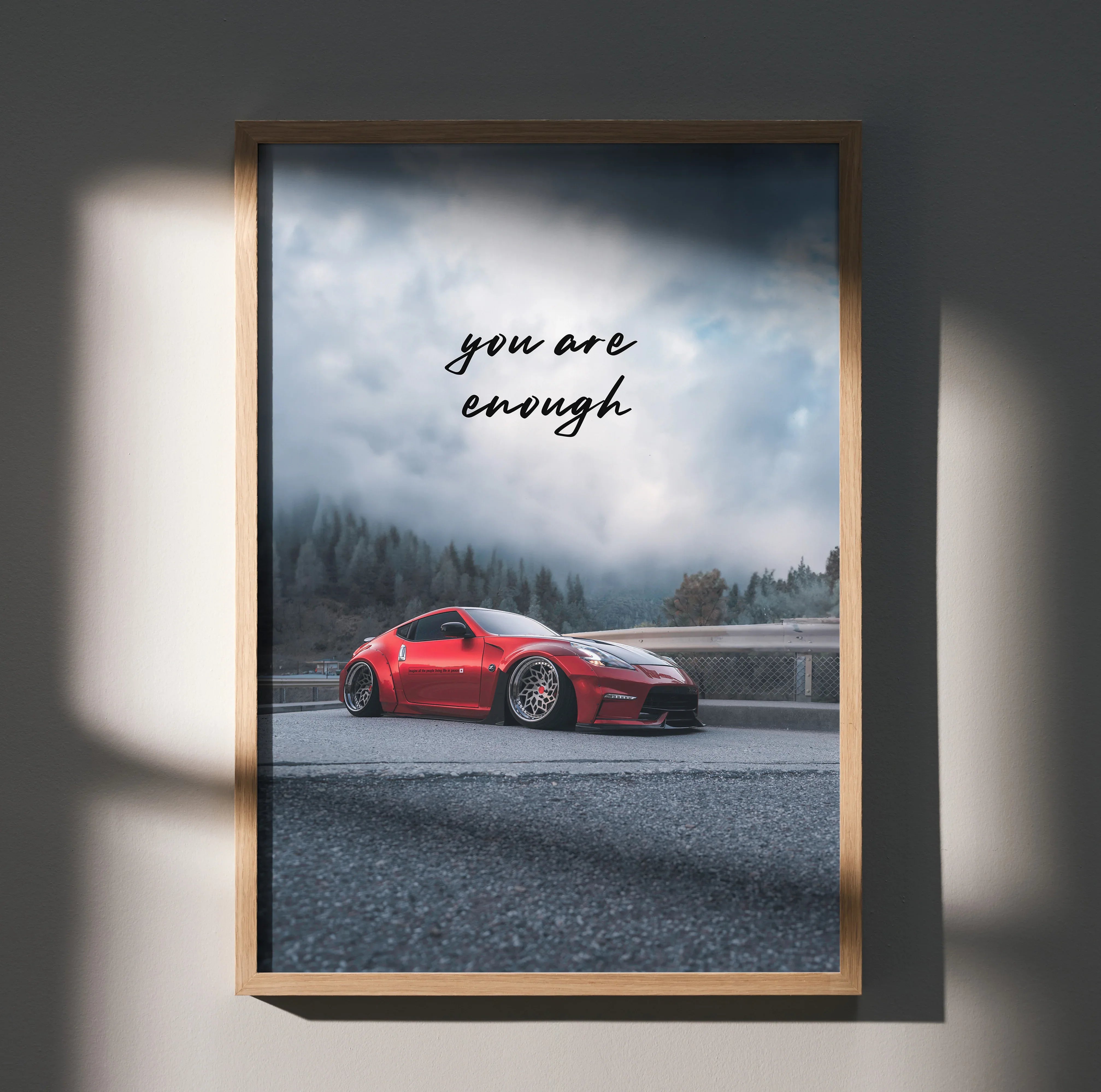 Motivational poster wall art featuring a red Nissan 370z on a foggy mountain road with "you are enough" text.