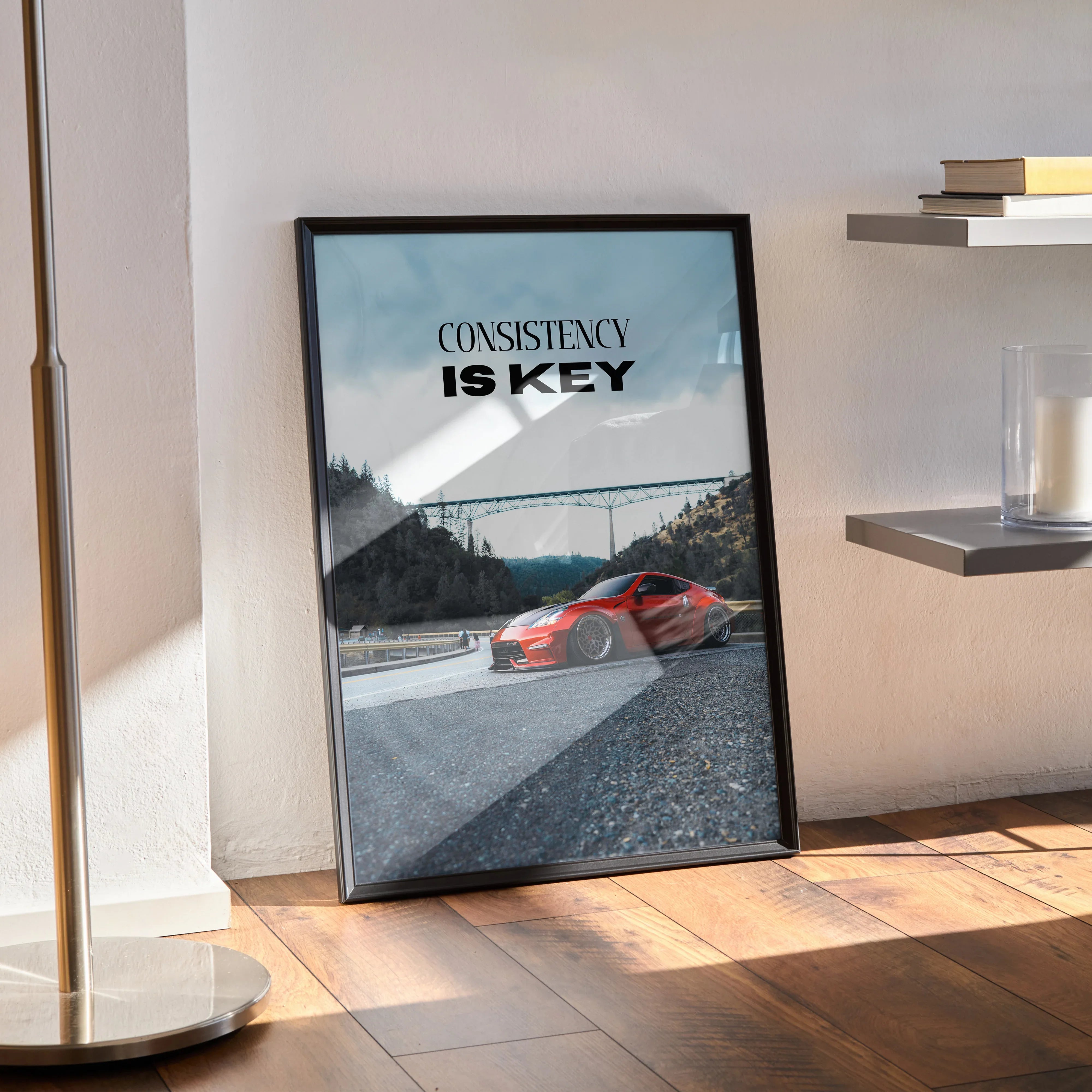 Motivational poster featuring red Nissan 370z on racetrack with "Consistency is Key" text wall art.