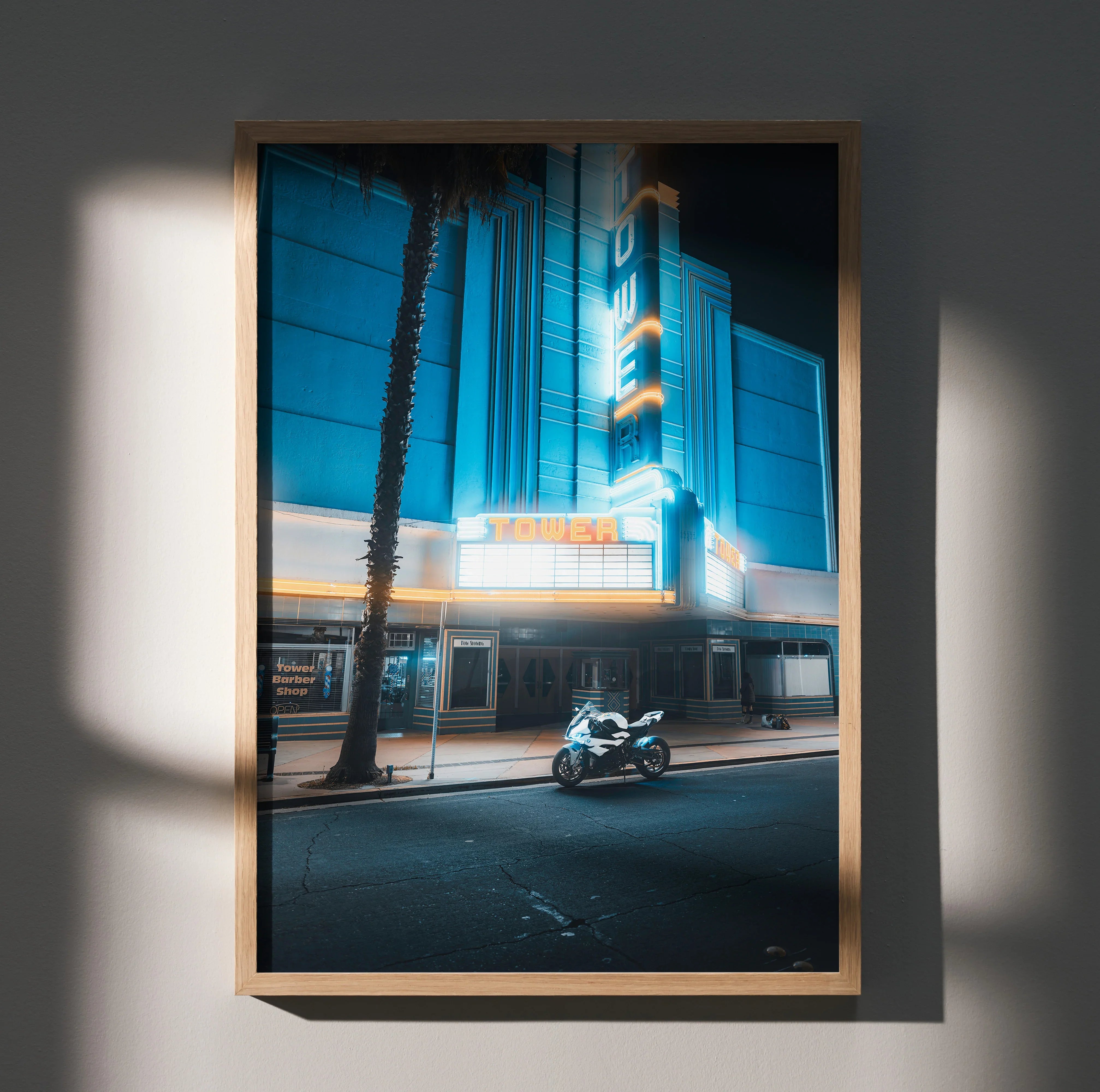 BMW S1000RR motorcycle night scene poster wall art with neon theater sign and palm tree.