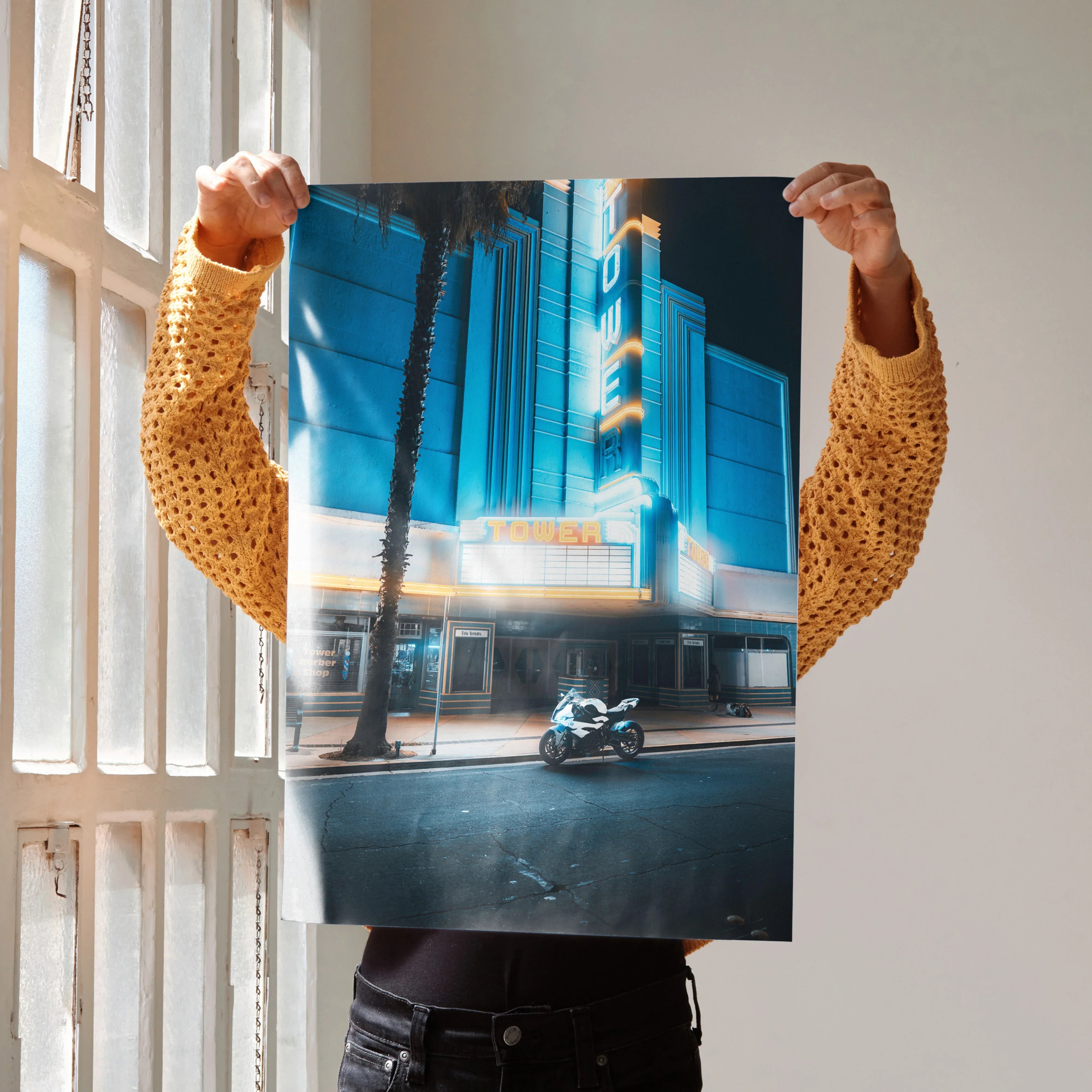 BMW S1000RR motorcycle parked in front of illuminated urban building poster wall art.