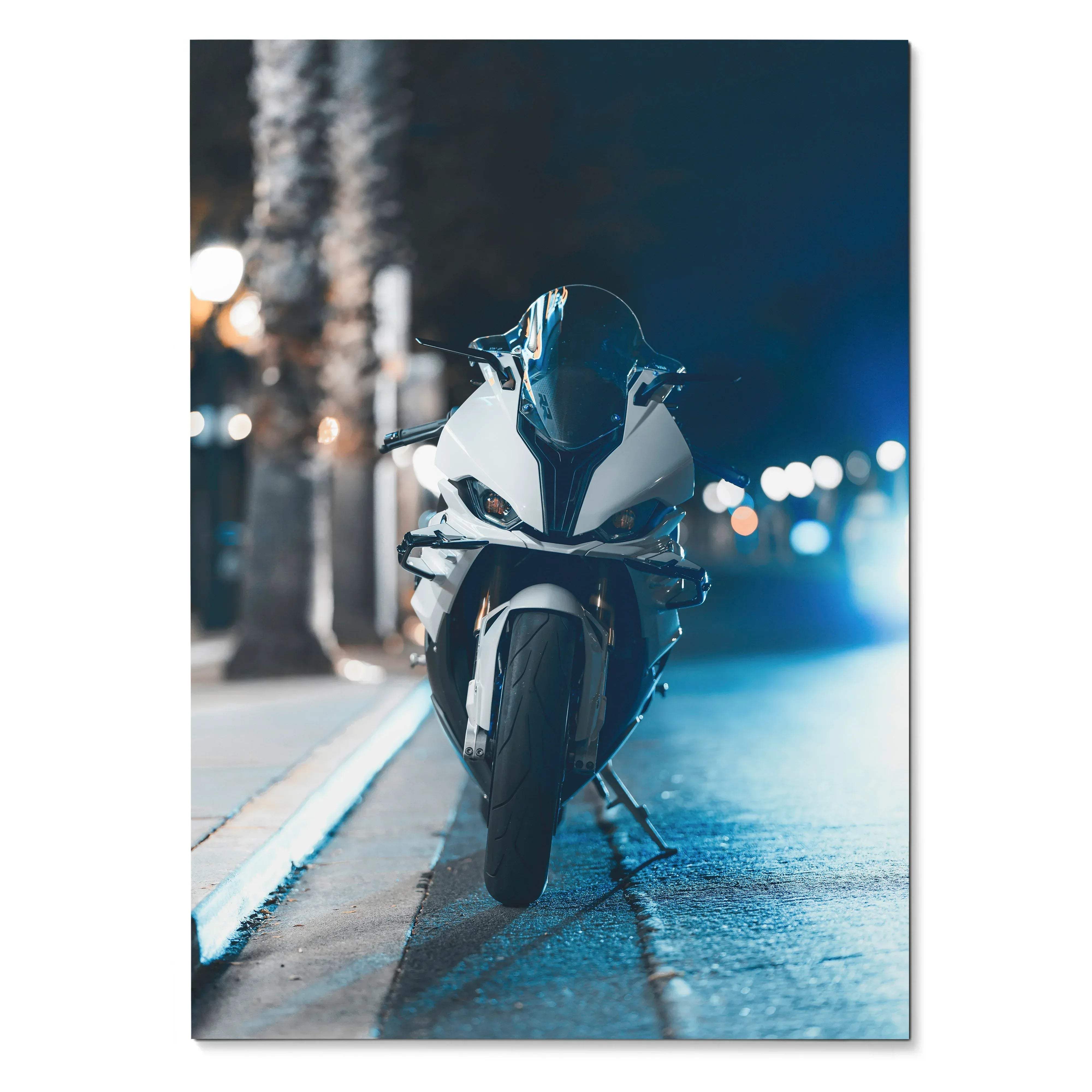 White and black BMW inspired S1000RR sport motorcycle with sleek aerodynamic design parked on wet city street at night