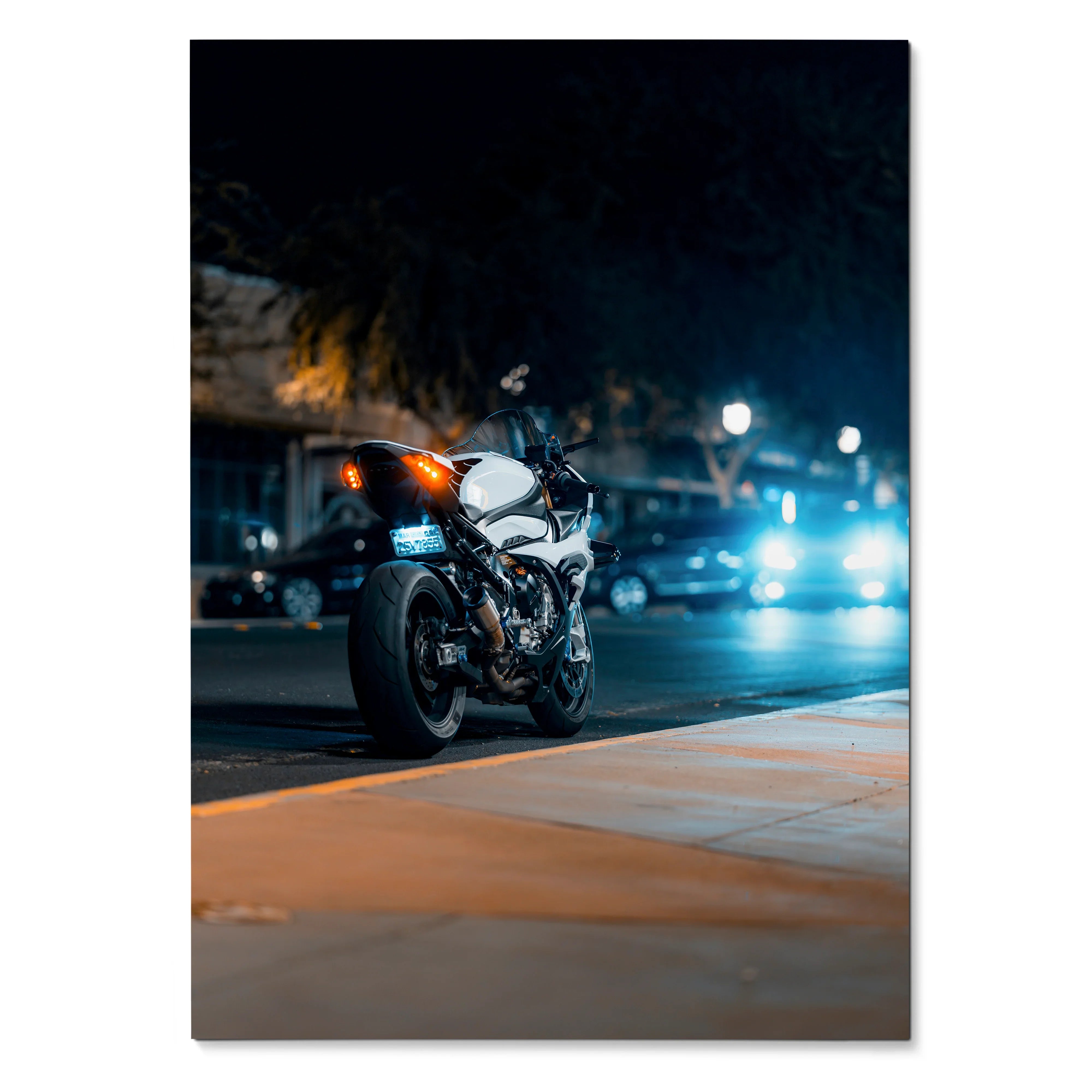BMW S1000RR motorcycle parked at night with blurred city lights poster wall art.