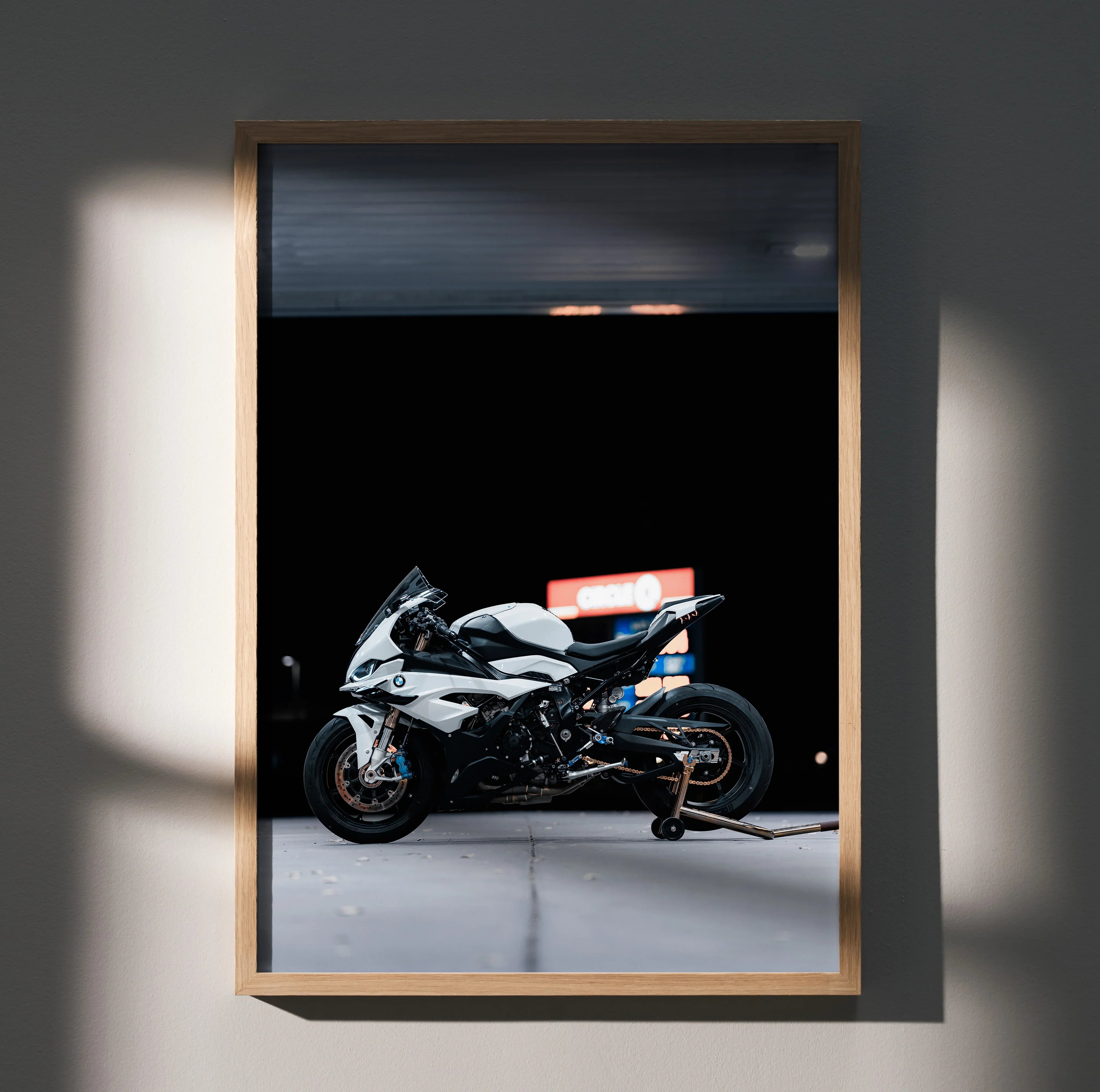 BMW S1000RR motorcycle wall art poster with black background in wooden frame.