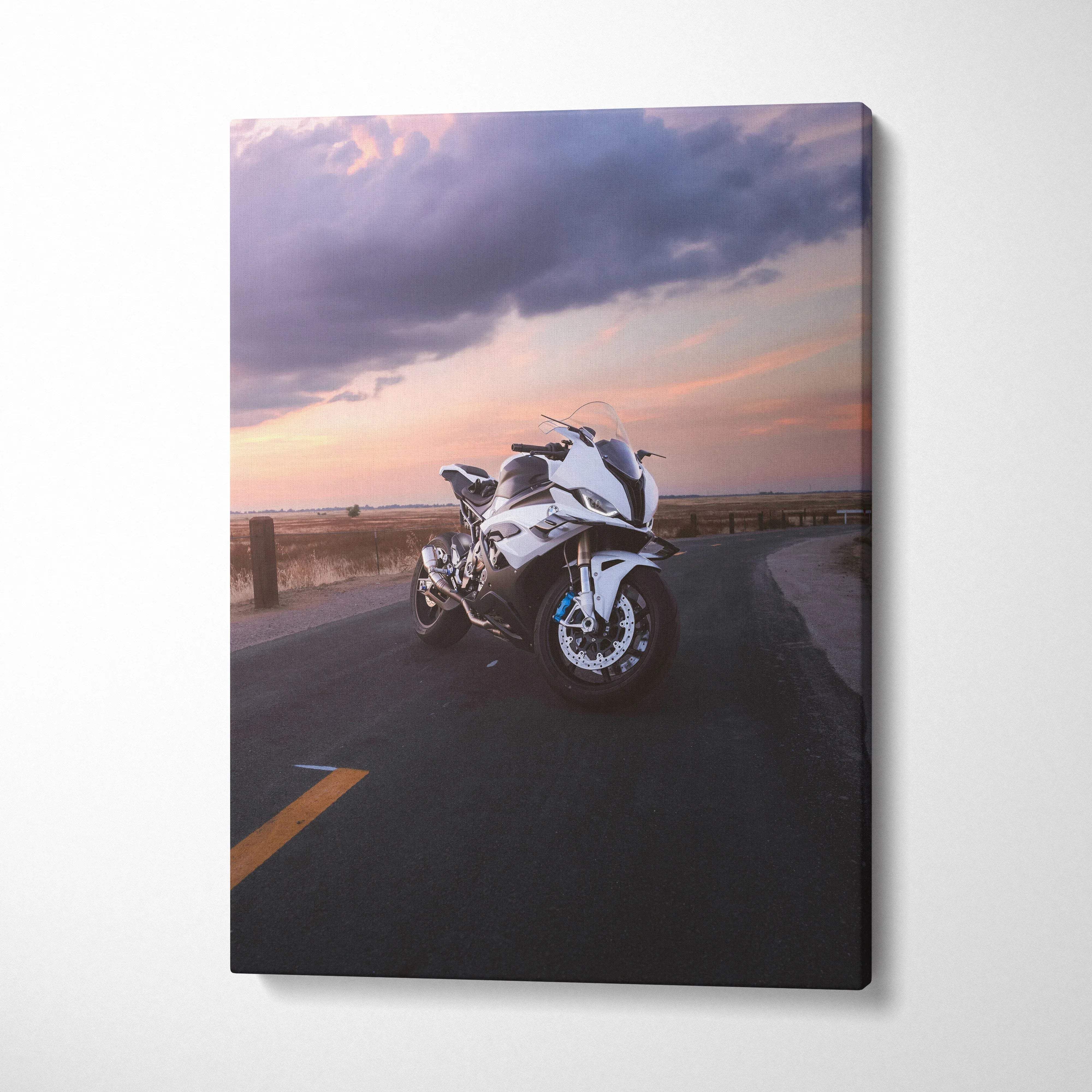 Vertical canvas wall art featuring a white BMW S1000RR motorcycle at sunset on an open road.