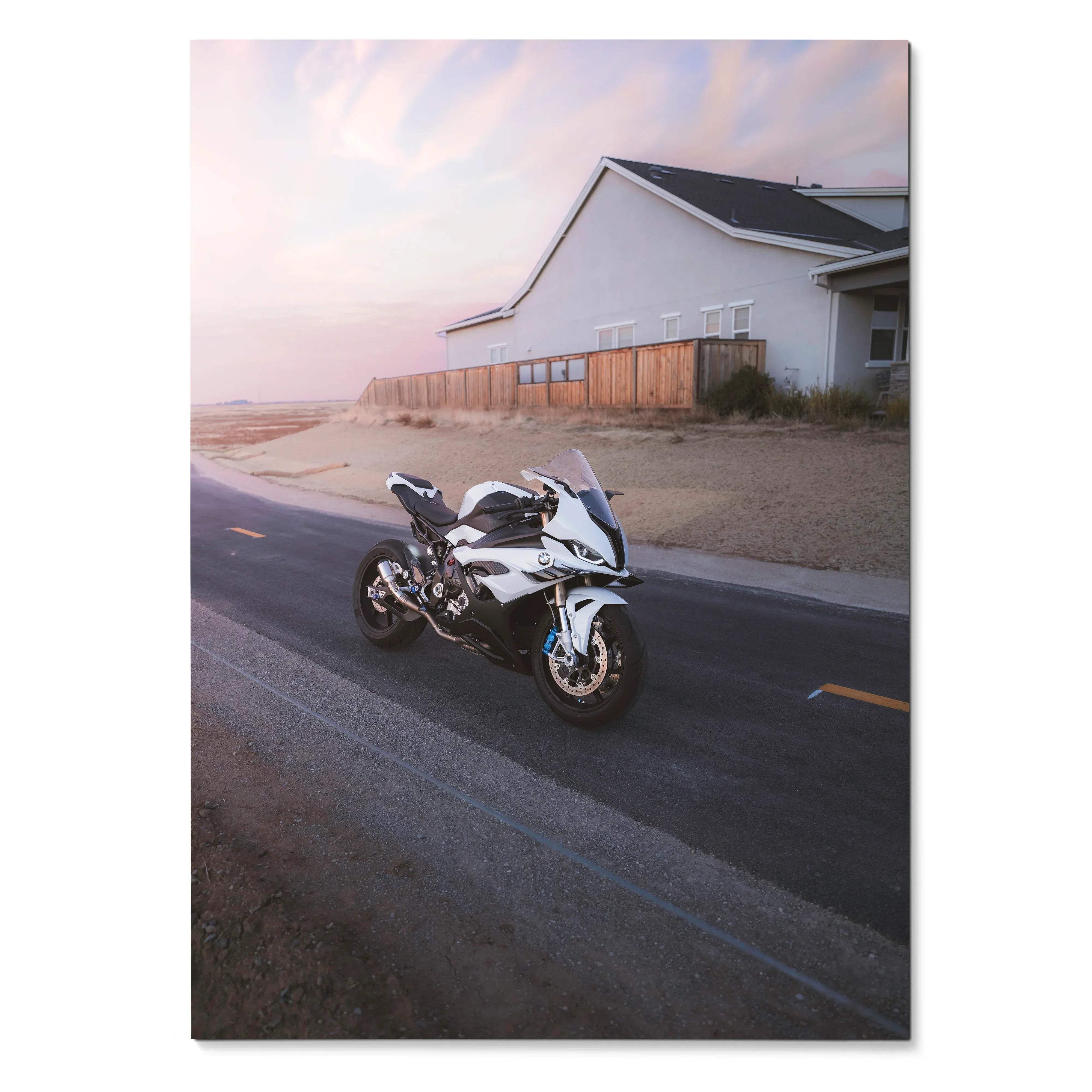 BMW S1000RR motorcycle parked by rustic building at sunset poster wall art.