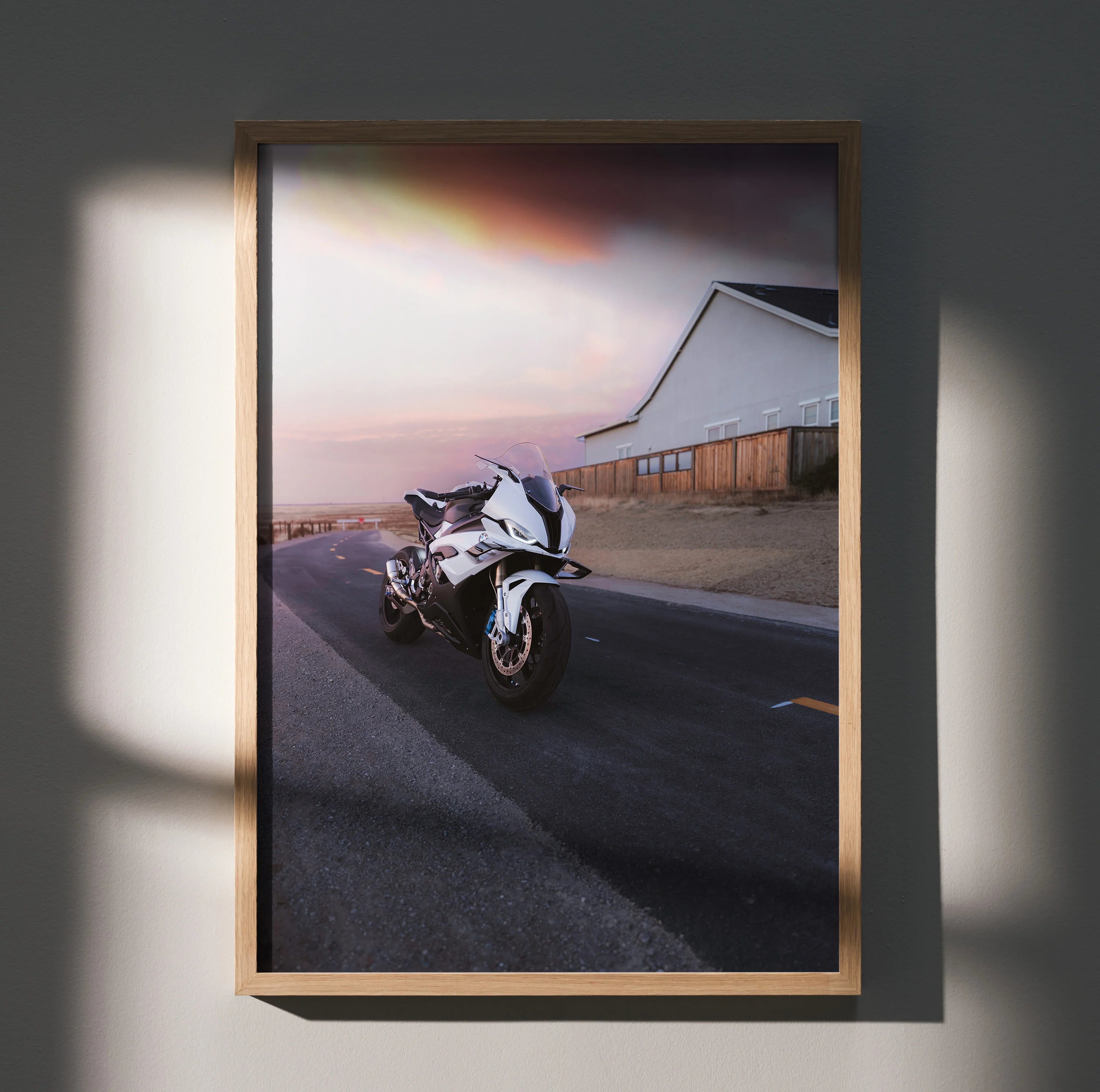 BMW S1000RR motorcycle poster with sunset backdrop, sleek white bike on road, modern wall art.